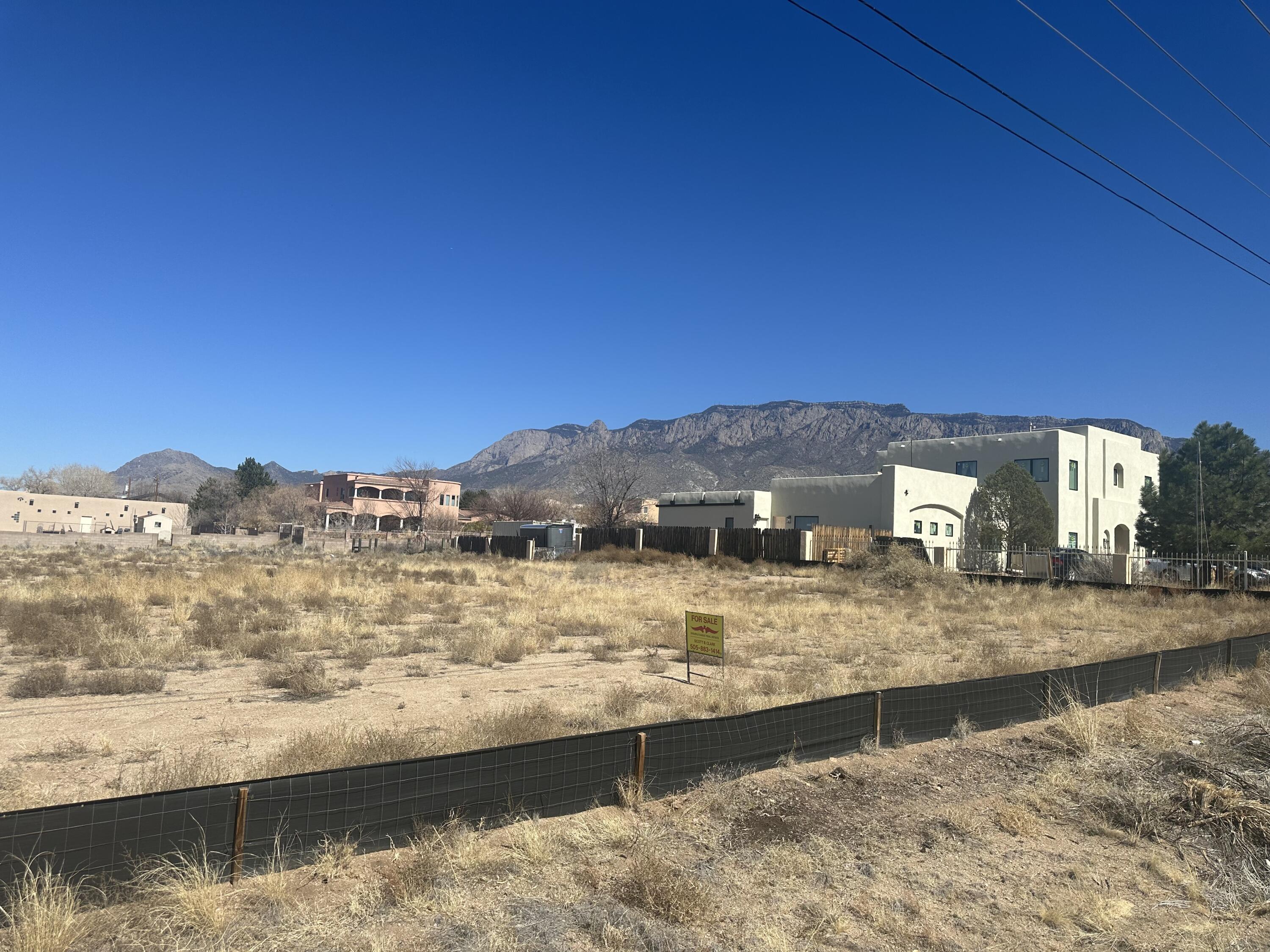 Great building lot on the North Side of the Street. This lot is almost completely flat. All the dirt work and pad site has been completed and ready for your home. Located in an area of new and nice homes. Be at Tanoan in less than a minute. The views of the Sandia Mountains from the back side of this lot are amazing!