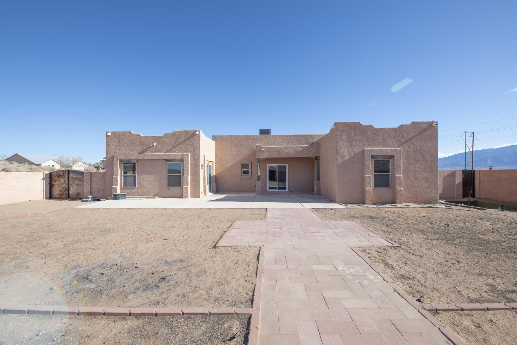 Discover this exquisite custom-built home at 5000 Baranca Ave SE in Rio Rancho, NM. Spanning 2,230 sq ft, this 3-bedroom, 2-bath home offers an open-concept design with a spacious kitchen featuring modern appliances and ample counter space. The living area is perfect for gatherings, while the primary suite provides a serene retreat with a luxurious en-suite bath and generous closet space. Situated on a 1.1-acre lot, the property has endless outdoor possibilities. The 2-car garage ensures ample storage and convenience. Located in the growing city of Rio Rancho, known for its stunning landscapes, excellent schools, and thriving community, this home combines comfort and elegance in a prime location.