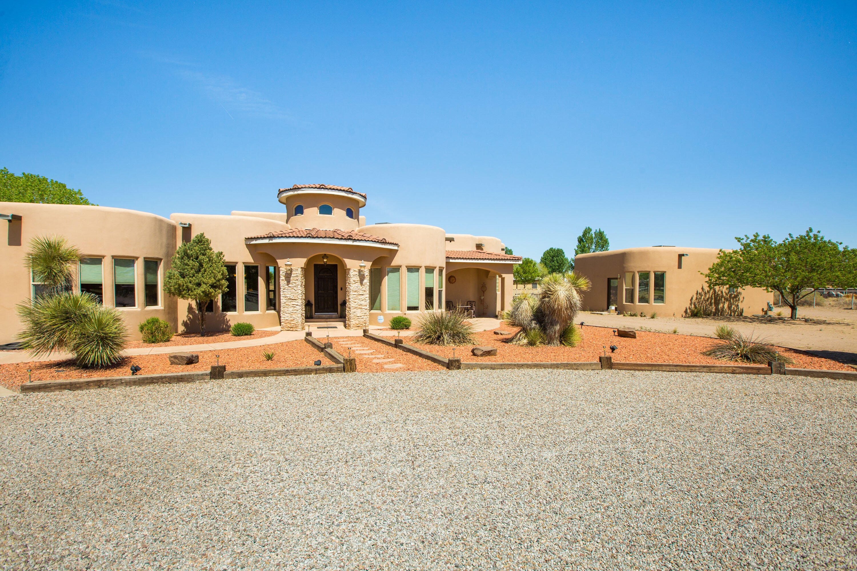 Exquisite Spanish Mediterranean home includes a Casita. Nestled on 1.25ac, located in the desirable Valle Verde Estates. The main house offers 4 bedrooms, 3 full bath, a home office with its own entrance, 3 car oversized garage, and a RV Carport. Enjoy the panoramic views from this open floor plan, which offers vigas, soaring ceilings with tongue and grove, barrel hallways, and nichos throughout. Beautiful travertine and Bamboo flooring heated by radiant in floor heating. Enjoy the evenings outside around the fireplace or pretend you're camping and huddle around the in ground fire pit.  The inviting Casita offers an open kitchen and living, an oversized bedroom, bathroom and back patio to enjoy your morning coffee, it can also be rented out for extra income.