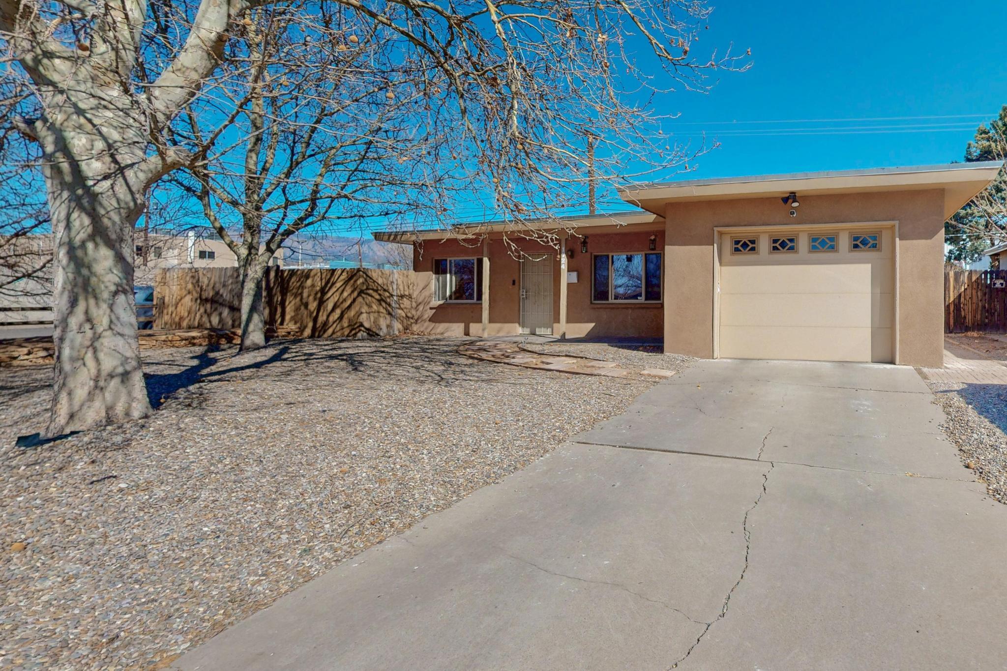 Welcome to this cozy and inviting home located in the Northeast Heights of Albuquerque. Situated on an oversized corner lot, this property offers plenty of space and privacy. The home features three spacious bedrooms and two well-appointed bathrooms, perfect for comfortable living. Enjoy the convenience of a one-car finished garage, providing secure parking and extra storage space. The front yard is landscaped with mature shade trees, offering a relaxing atmosphere. In the backyard, you'll find a large shed equipped with power, offering the flexibility to serve as a workshop, additional storage, or even a garage space for your projects or hobbies. Don't miss out on the opportunity to make this home your own!