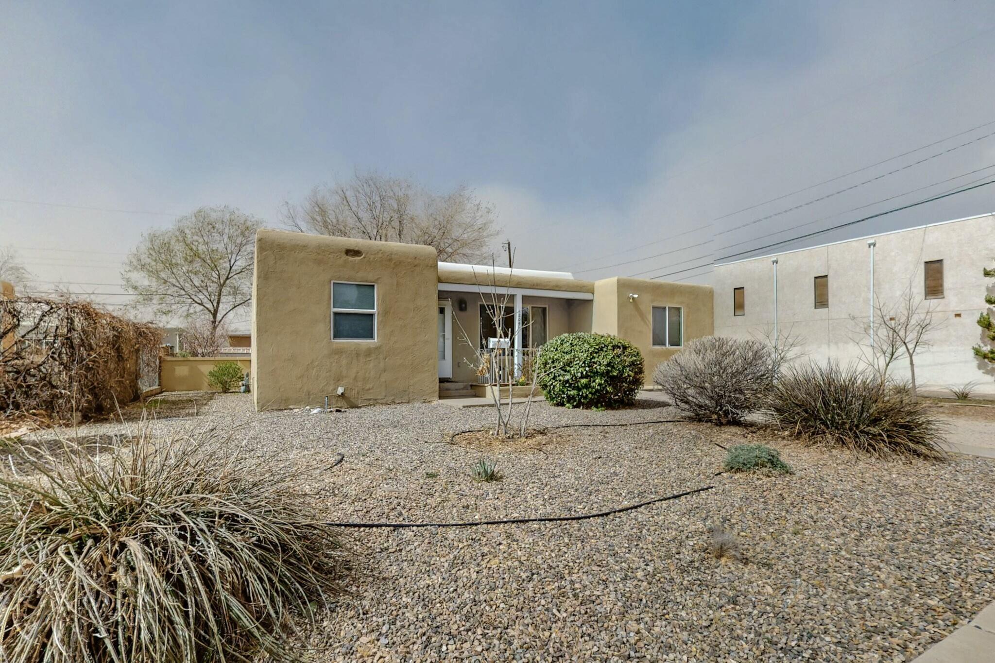 This two-bedroom, one-bathroom house boasts exquisite wood floors and an ideal location. It is conveniently situated near the University of New Mexico, Central New Mexico College, Interstate 25, Kirtland Air Force Base, Nob Hill, and numerous other amenities. Enjoy the natural light from the large windows.The property has been well maintained and features a refrigerated air conditioning system, a spacious backyard, full-sized washer and dryer hookups, and a secondary living area that can be utilized as a home gym, entertainment room, or office.Seller is also including separate deed to the lot north of the home, between the property and the alley.