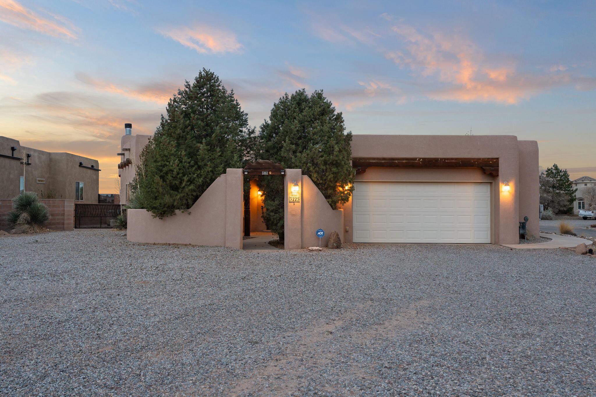 Step inside this beautiful southwestern style home in the heart of growth in Rio Rancho. Situated on a spacious half-acre lot with beautiful mountain views, this Southwestern-style home offers both comfort and character. With three bedrooms, two full bathrooms, and an additional powder room, the open floorplan is designed for both everyday living and entertaining. High-quality finishes throughout the property enhance the warm and inviting atmosphere throughout the home.The living room features a cozy fireplace, perfect for those cold winter evenings. The backyard is fully landscaped and has a fireplace of its own, providing a peaceful outdoor retreat anytime. Additionally, an extra lot behind the home offers the opportunity to expand the backyard.