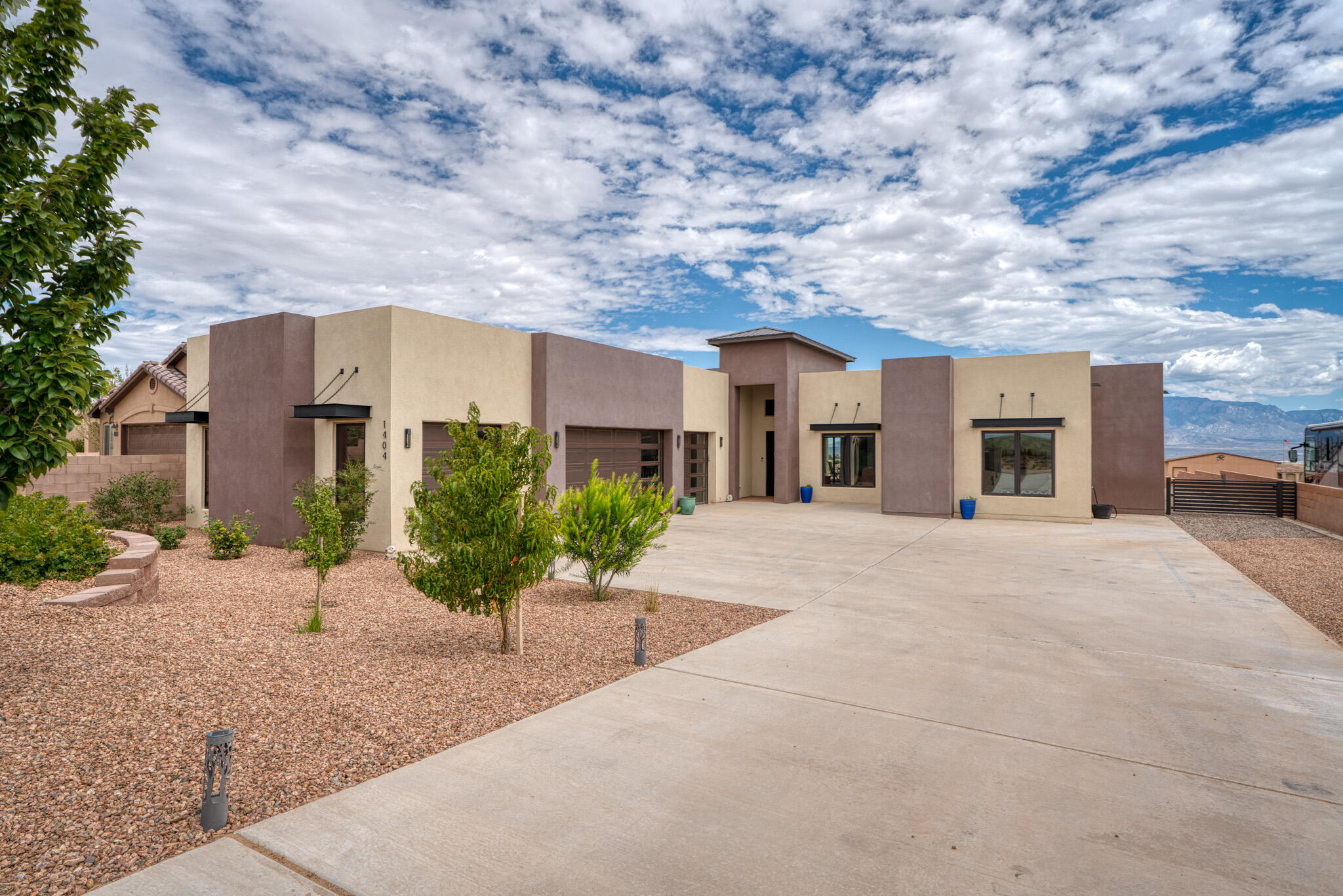Incredible views &  gorgeous custom home. Modern style in this single level home. Made for entertaining w/an open floorplan, large glass doors/windows make the most of the view and access  spacious covered patio. Above the patio find a low maintenance composite deck taking advantage of 360degree views. Huge primary suite with spa like bathroom, soaking tub w/fireplace, huge walk in shower & an awesome walk in closet w/access to the laundry room. Each bedroom has access to a bathroom, plus an office with custom barn doors.   Half acre lot is nearly entirely block walled & landscaped. Bring the toys with backyard access & oversized epoxy floored 4 car garage. Motorized blinds, water softener and more. Why build when you can just move in? Free car washes too!