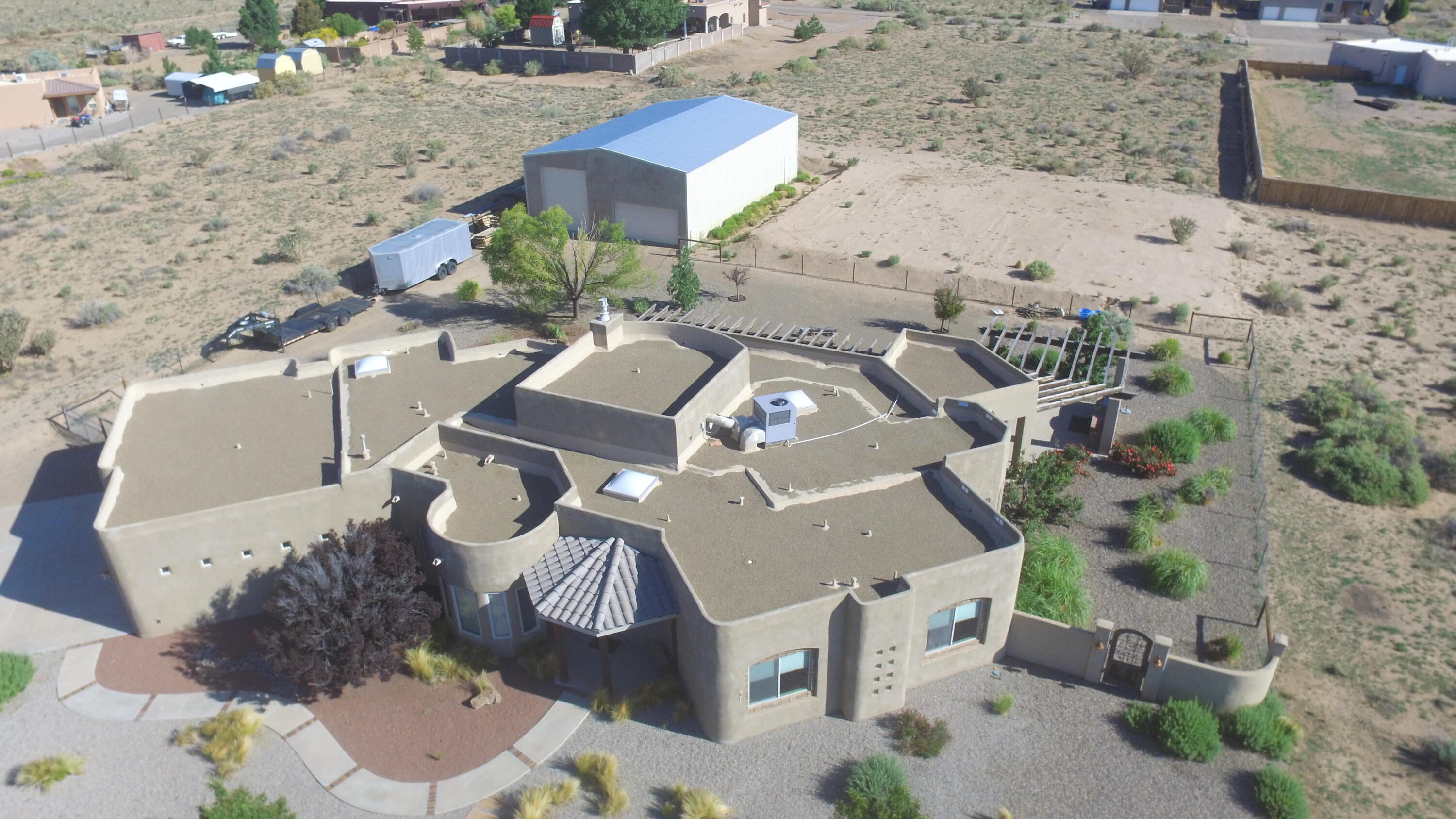 This beautiful custom home sits on an acre and has stunning mountain and sunset views! The home features a 14ft vaulted ceiling w/hand-carved wood beams, kiva fireplace, tile medallions & variance wall finishes throughout. Large gourmet kitchen features custom cabinets, double ovens & two islands! The owner's suite has two vanities, large walk-in closet, jetted tub, snail shower and access to the patio. The fully landscaped yard with over 1,300 sqft of terrace & patio space, pond and an outdoor kitchen is an entertainer's delight! Huge 2,400 sqft (40'x60'x16') insulated RV garage/shop with concrete slab has a 14ft tall RV door and a 2 car garage door. Home is energy efficient w/high R-values and recent spray foam roof.