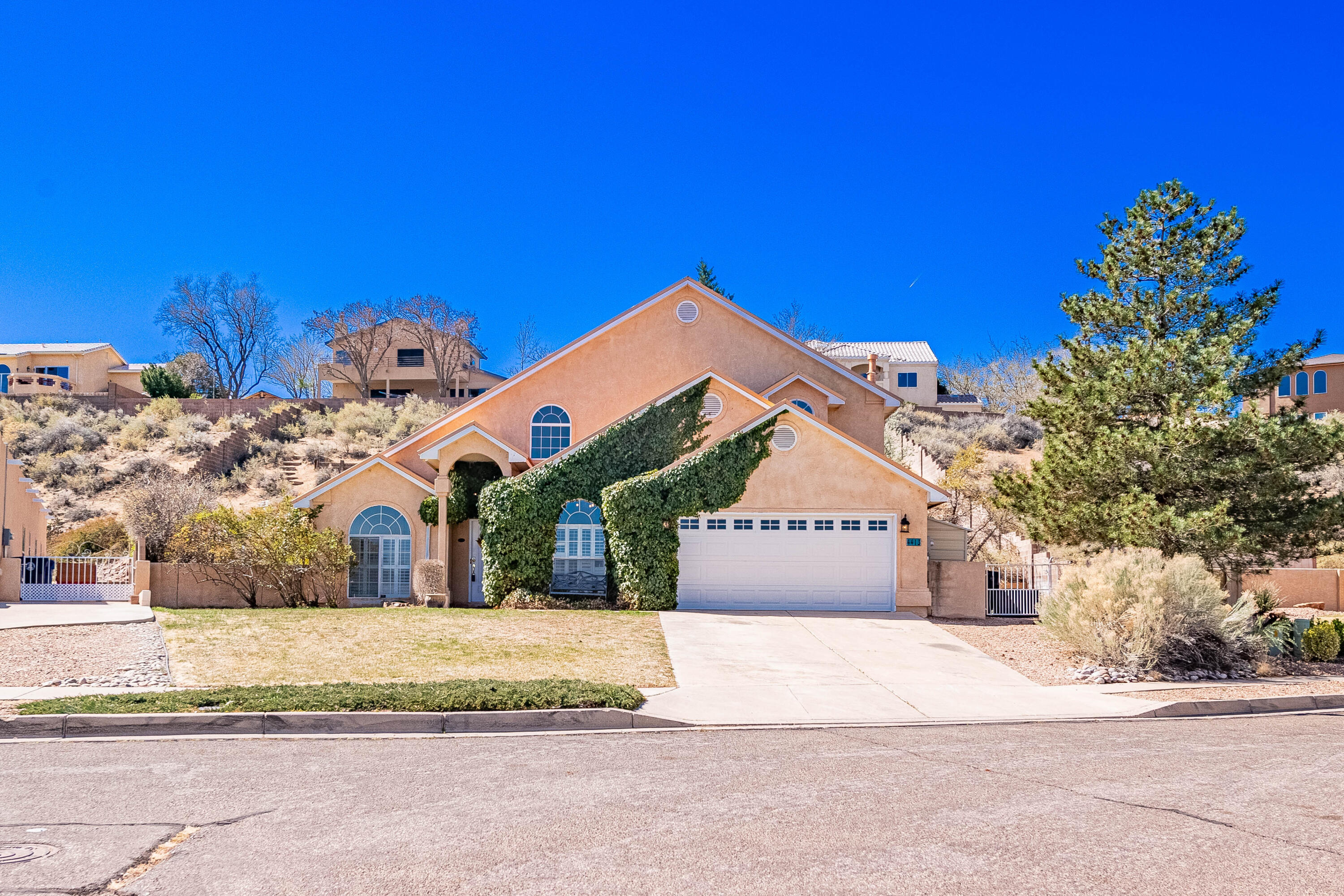 Discover this stunning custom home in 7 Bar Loop, nestled in a quiet cul-de-sac. This turn-key beauty features a R-panel metal roof, solar panels with battery back up, and an updated kitchen with granite countertops, a farm sink, stainless steel appliances, and a spacious island. Solar panels to be paid off at closing! Enjoy the cozy gas fireplace and French doors. The laundry room offers stackable appliances. The .48-acre backyard is a dream with raised garden beds and a shed. The primary suite is on the main level, along with a versatile 5th bedroom/office. A must-see, schedule your showing today!