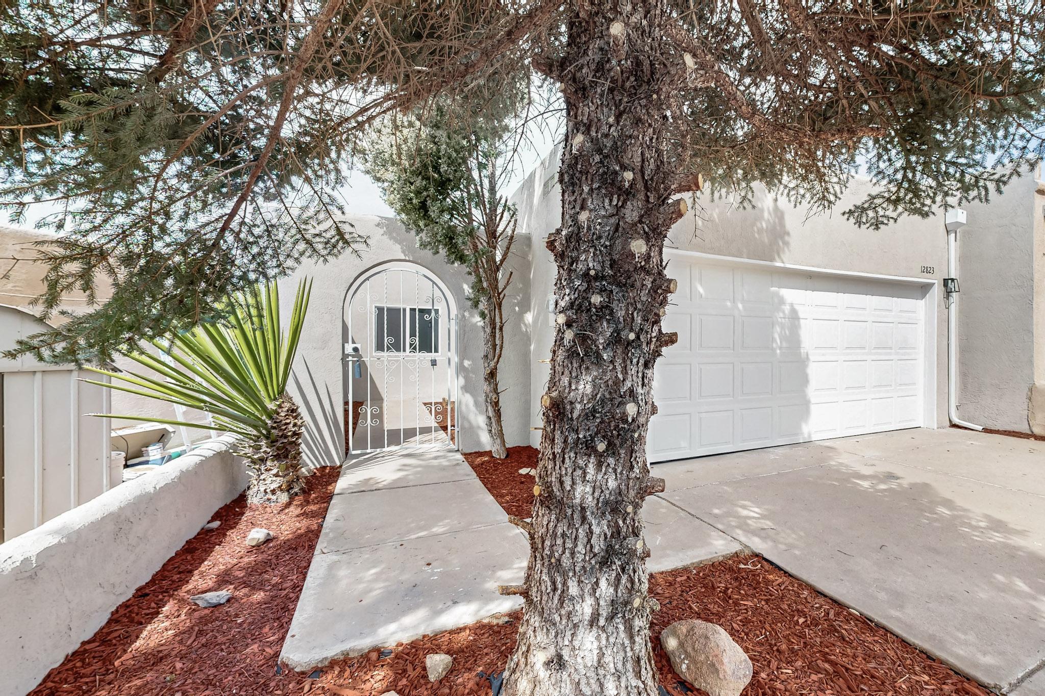 Nestled in a peaceful NE Heights neighborhood on a cul-de-sac, this remodeled townhome offers a serene retreat. Minutes from the foothills, hiking paths, and biking trails, this residence features two bedrooms, two bathrooms, and a two-car garage. The spacious open living room is adorned with skylights and a brick fireplace. Recent updates include new kitchen cabinets and countertops, stainless steel appliances, and renovated bathrooms with beautiful surround tile and modern fixtures. Enjoy the outdoors from the covered balcony leading to the backyard. With no HOA fees, this property is ready for immediate occupancy.