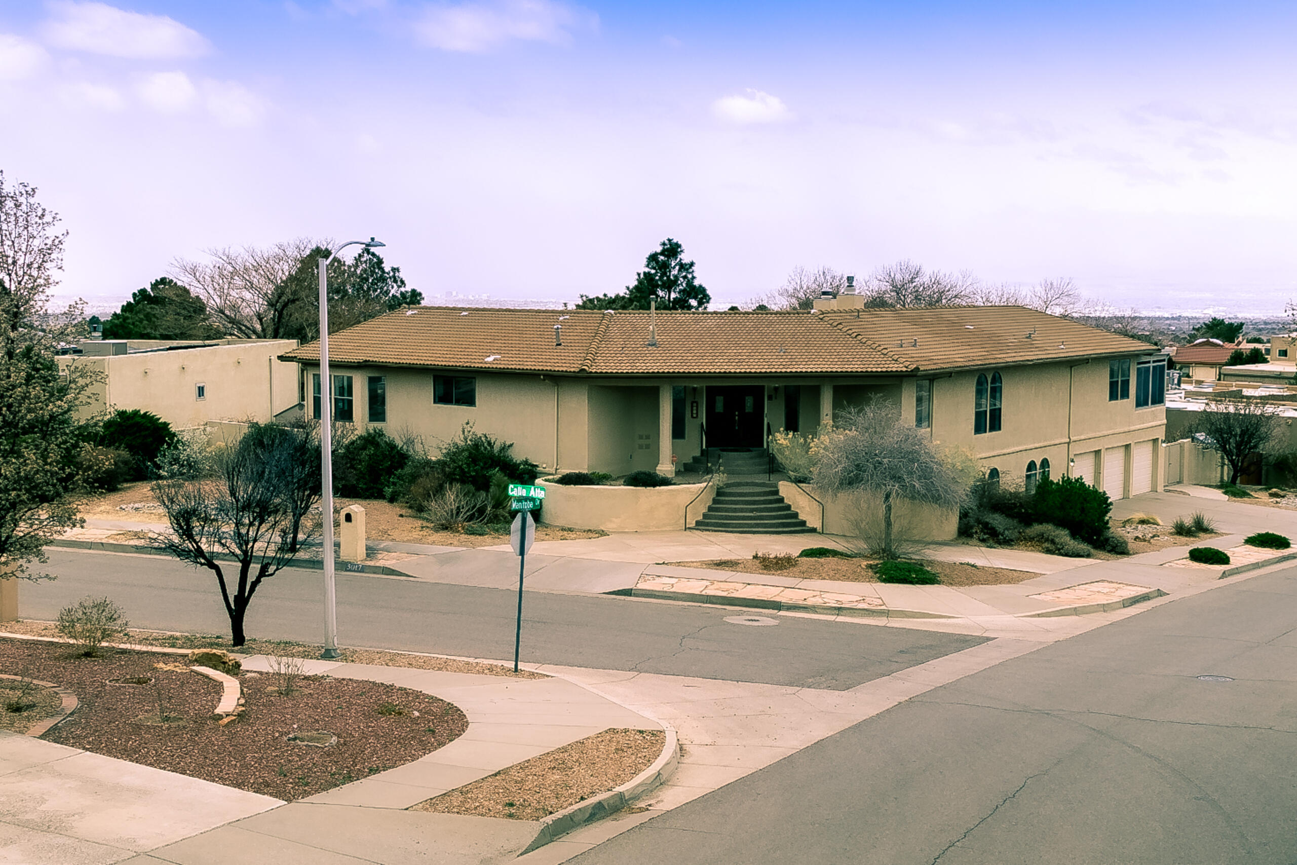 Welcome to this stunning home in the highly sought-after Glenwood Hills neighborhood in NE Heights Albuquerque that is thoughtfully designed for both entertaining and everyday comfort.Step into the fully renovated kitchen, where high-end finishes, an expansive island and breakfast bar, 8 burner dbl oven range and a commercial-size refrigerator and freezer create a chef's dream space--all framed by breathtaking mountain views. A spacious walk-in pantry adds convenience, while the elegant dining room offers picturesque views of the mountains and city lights. The light-filled living room invites relaxation, featuring wood beam ceilings, a cozy sitting area, built-in bookcases, and a charming gas log fireplace.