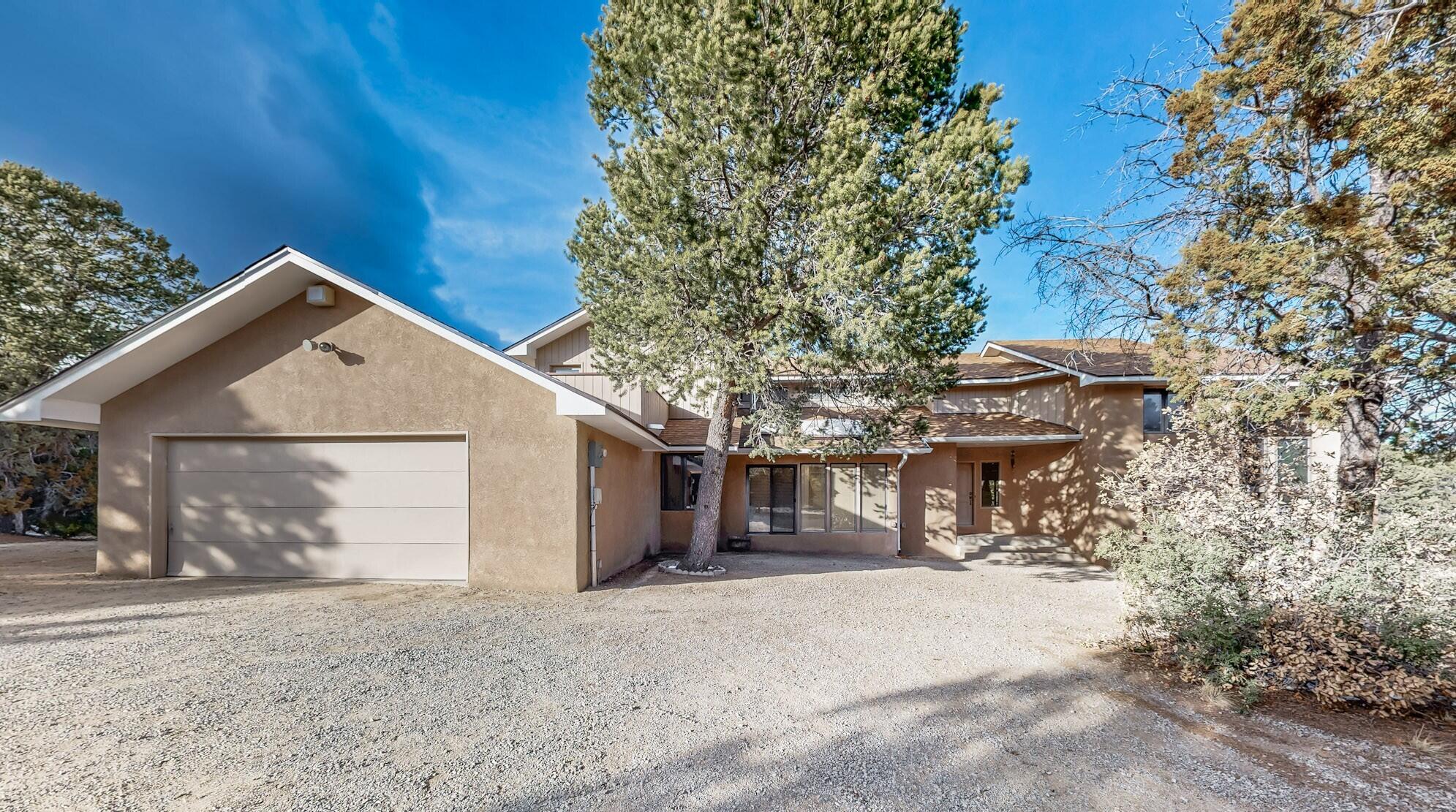 One of a kind Equestrian property. Exceptional Passive Solar home showcasing 16'' Trombe walls. Dramatic Greatroom has vaulted ceilings, a massive stone fireplace with a beautiful flagstone hearth, wet bar, & wall of Hurd windows. Stunning kitchen and admire the extraordinary woodwork, roll top desk & cabinet doors hand-carved by Master Craftsman Ernie Torres. Double ovens and huge center island add to the artistry & design.  Cozy brick-floored solarium is perfect for morning coffee.  Each level has two bedrooms with full bathrooms, plus a guest powder room. The primary suite has a private balcony. Fenced 4-acre lot has a 1750SF barn including a tack room, 3 horse bays, feeders, water supply for stalls & a 120'x70' riding arena. Discover space, views & serenity 20 minutes from ABQ!