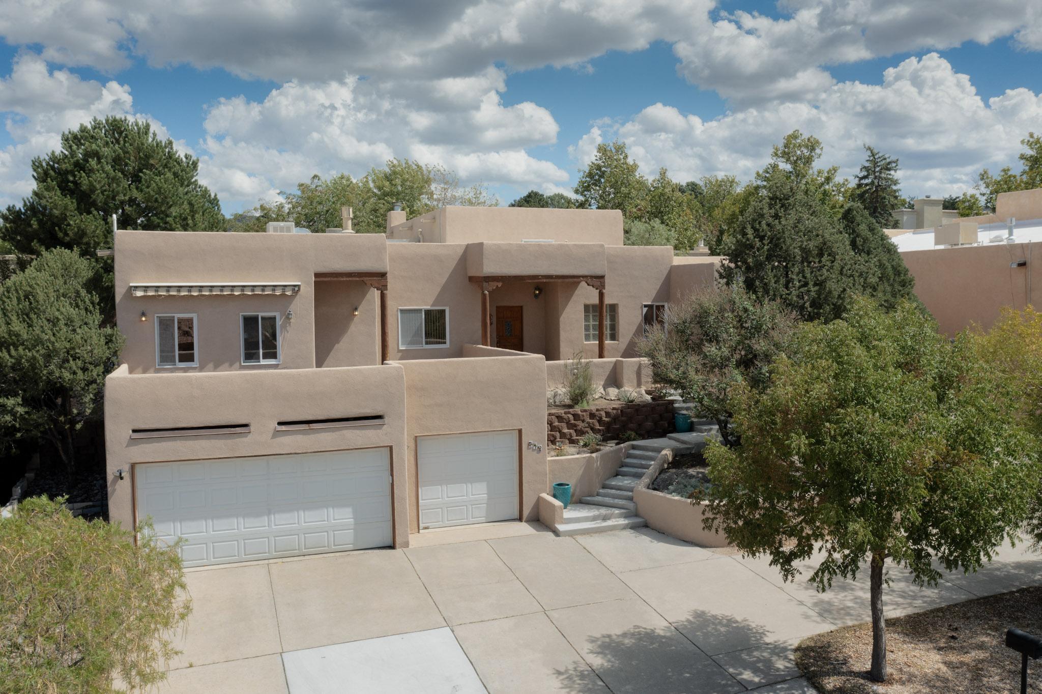 Beautiful Southwestern  Oasis, peace of mind and tranquility.  So many updates!!! Nestled in the beautiful Four Hills Golf Course Community, this stunning southwestern-style home offers the perfect blend of beauty, style, and modern elegance. Boasting traditional architectural elements combined with contemporary upgrades, this property is truly one-of-a kind. This home is not only a sanctuary in terms of design but also energy-efficient, with an owned solar panel system, a tankless water heater,  recently upgraded evaporative cooling, and new (2025) baseboard heating boiler ensuring low energy costs and a minimal environmental footprint.
