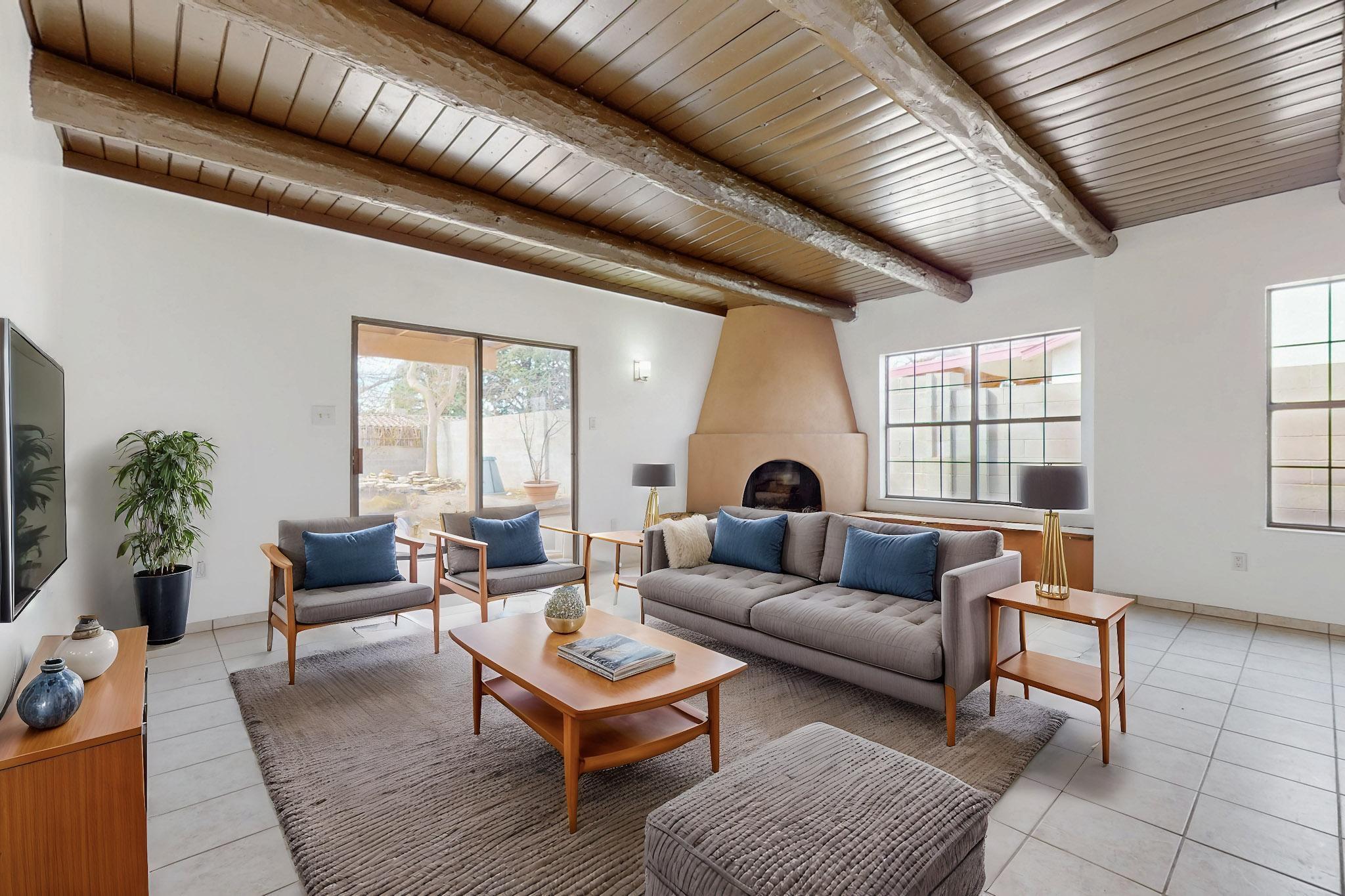 Full of Southwestern charm, this home features an inviting adobe fireplace and stunning wood beam ceilings in the living area. The kitchen offers ample counter space and a stylish brick backsplash. Spacious bedrooms provide comfort, with an upper bedroom opening to a cozy private deck. The backyard is a blank canvas, ready for your personal touch. Warm and welcoming, this home blends character and comfort in a truly special way!OWNER CARRY- -CALL FOR OTHER TERMS-gorgeous. This home is huge- a large home with room to grow.