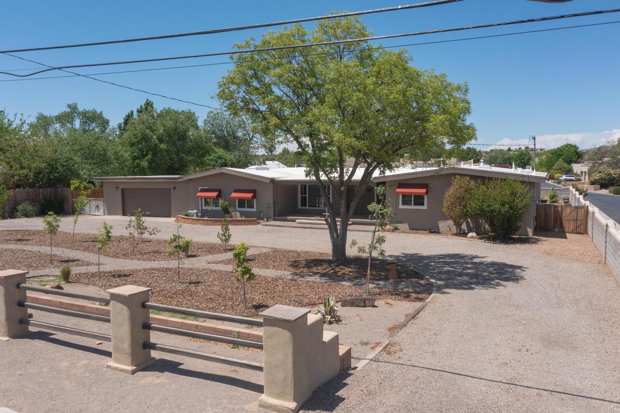 Beautiful North Valley home. Westside of Rio Grande Blvd. Walking distance to the Nature Center. The Bosque trail is at your finger tips with hiking and bike paths to enjoy. Two living areas, one with a wood burning fireplace making the room cozy.  4 bedrooms, 4 bathrooms on .49 acres. The kitchen features granite counter tops, SS appliances, an island for casual dining and plenty of space to entertain. Large family room with wet bar and 3/4 bathroom. Newer TPO roof with warranty. The back yard has a newly drilled irrigation well, a pond and new trees around the property. Conveniently located near shopping, dining and Old town. Easy access to I-40. Country living in the city!