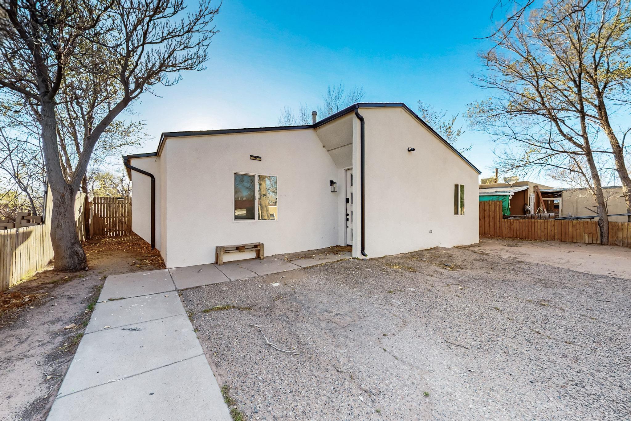 This stunning, newly remodeled home is sure to capture your heart! Nestled in the vibrant core of Albuquerque, this property places you within a stone's throw of the city's most coveted attractions-- all less than a mile away. Imagine strolling through the serene Botanical Garden, casting a line at Tingley Beach, visiting the Zoo, or exploring the historic charm of Old Town. The Rio Grande River and Bosque offer natural beauty, while Central Avenue and Downtown Albuquerque pulse with urban energy--all just steps from your door! This exceptional home blends modern luxury with thoughtful design, featuring a seamless wraparound open floor plan, gleaming new flooring, a sleek roof, energy-efficient windows, custom cabinetry, and granite countertops. refrigerated air.