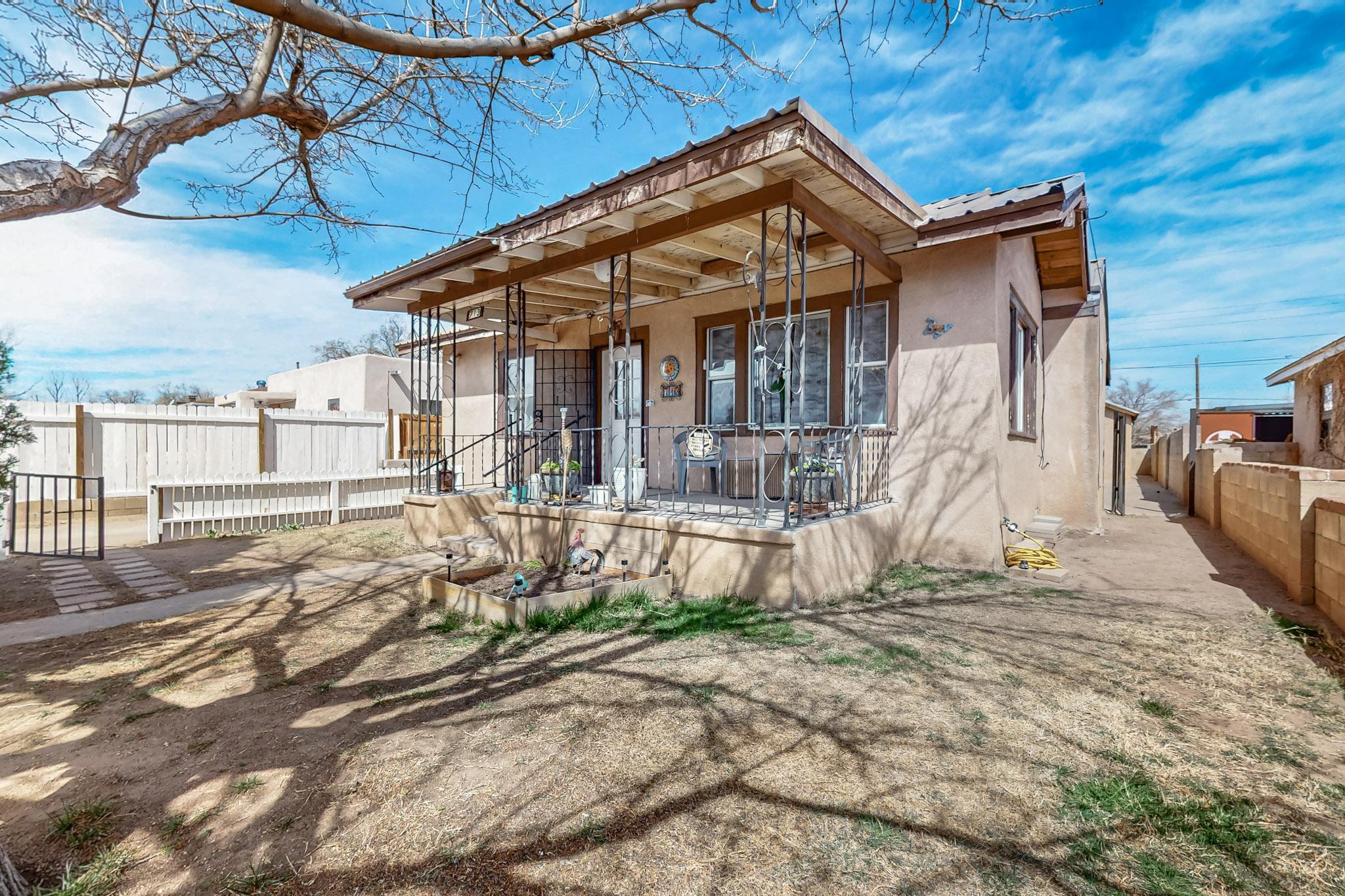 What a charming Craftsman style home! With high ceilings with decorative tiles, original hardwood floors, built-in shelving, a great area for a future wood stove if you'd like, and a fantastic front and back yard with plenty of storage in your permanent shed, this home has so much to offer.There's even plenty of room for a casita to be built in the future if you ever desire. Located just seconds from the exciting developments at the Indian Pueblo Cultural Center, you'll love living near the new La Montanita Co-Op! If you're a hiker, biker, and recreation fan, you'll also enjoy the parks and acequias in close proximity. The home is priced to sell as-is. This home qualifies for a loan program with $17,500 toward your closing costs as well!