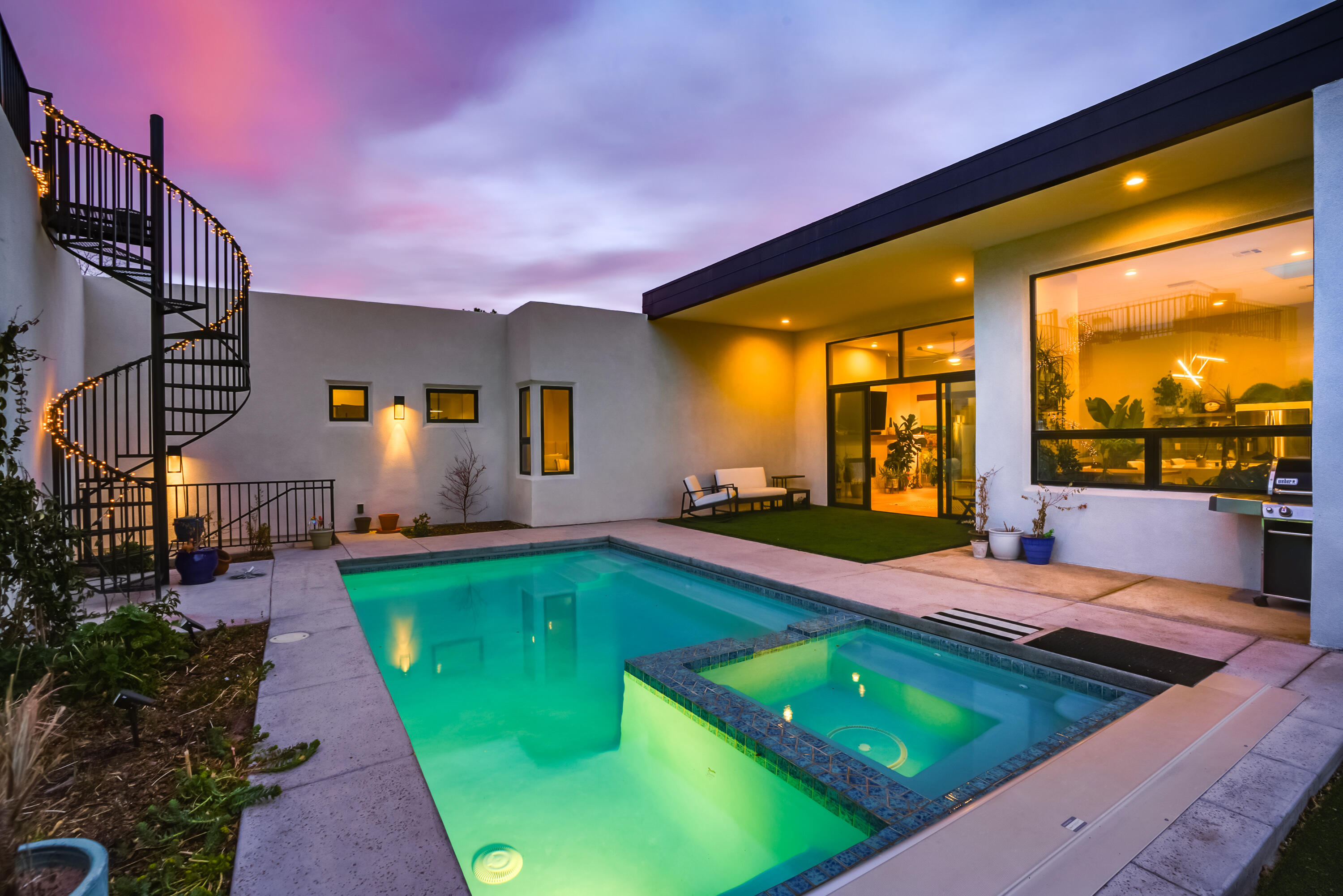 This one is a unicorn! Welcome to this modern masterpiece in the heart of the highly sought-after Ridgecrest neighborhood.  Built by Las Ventanas Homes in 2023, this one-story residence seamlessly blends contemporary design with luxurious comfort, offering a NM Green Build GOLD certification.  Step inside to find an open-concept floor plan with soaring ceilings, expansive windows, and sleek architectural details. Outdoor living is elevated with a stunning pool, perfect for cooling off on warm NM days, while the roof deck provides the ultimate vantage point for enjoying panoramic mountain views. Complete with RV garage offering ample space offering ample space for your adventure gear.  The gourmet kitchen boasts top-of-the-line appliances, quartz countertops, custom cabinetry, perfect for