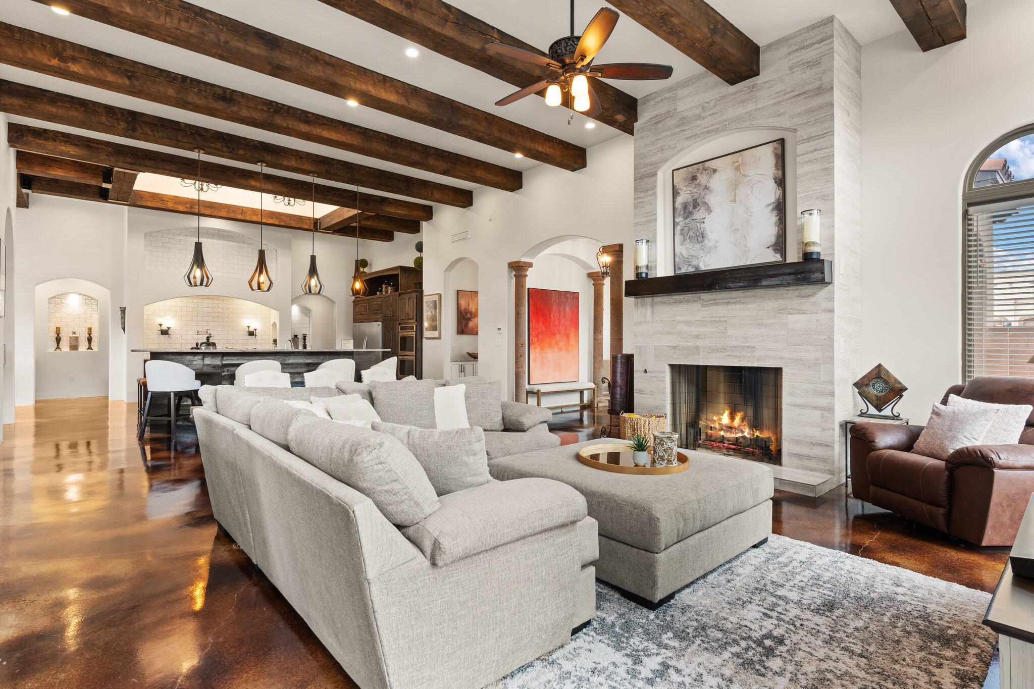 Nestled within the prestigious North Albuquerque Acres, this expansive residence offers an unparalleled living experience. Spanning a generous 7,222 square feet, the home is thoughtfully designed to accommodate multigenerational living, providing ample space and privacy for all. With five bedrooms, six bathrooms and a four car garage comfort and convenience are paramount.Upon entering, you'll be greeted by elegant living spaces, including a formal dining room perfect for hosting gatherings, and a recreation room designed for entertainment and leisure. The home features both a living room and a separate living lounge, ensuring everyone has their own personal retreat. The stained concrete flooring throughout provides a pallet of contemporary lux, waiting for your interior design ideas.