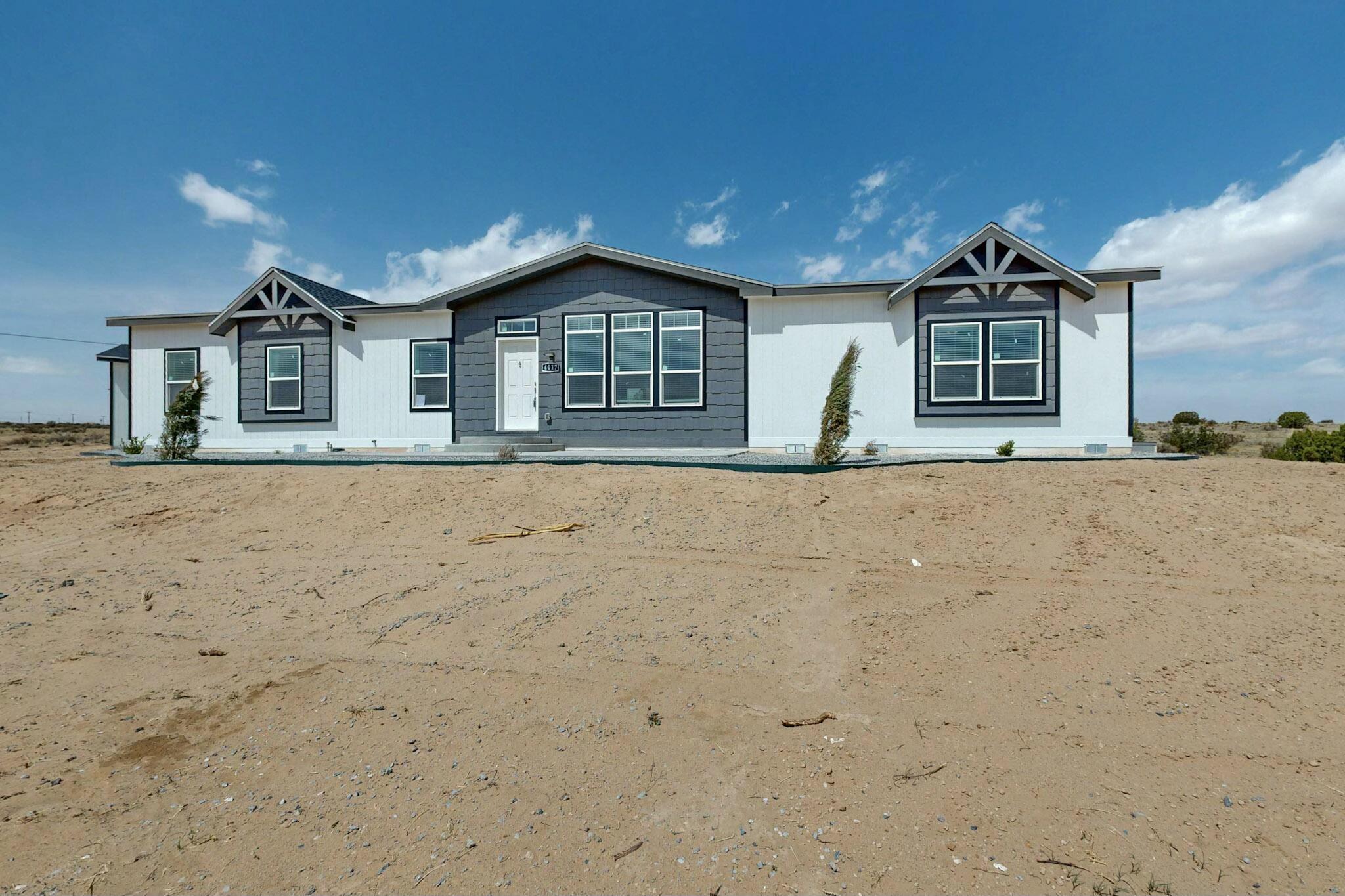 This brand new Clayton E-Built Home is situated in North Rio Rancho near the Armory, it's within the Rio Rancho School district, peaceful living yet close to all the shopping, restaurants and amenities. spectacular views of the Sandias from the 20X10 front concrete Patio This Home features tape & textured walls, 9 ft ceilings, Low-E windows with lots of natural light. Open chefs kitchen with huge island, solid surface counter tops and a gas cook range, microwave built into the Island, & a Large walk-in Pantry. Primary bath has walk-in shower with a bench and double entrances, seperate Vanity counter, double sinks and a long soaking tub. this 4 bdrm 2 Ba home also has 2 living areas and a dining area as well. 2 car garage, back porch, outdoor LED lighting, Come see it today