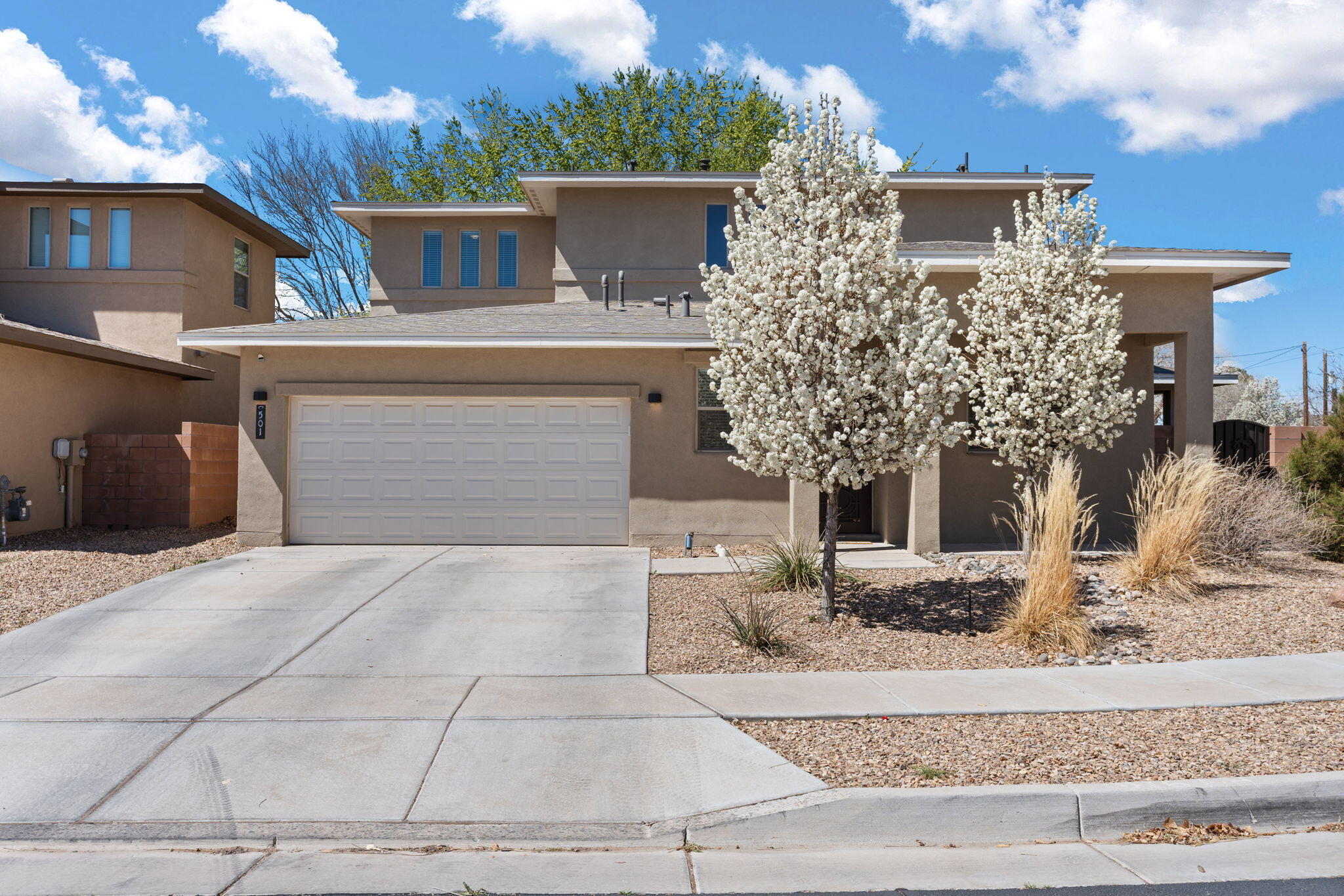 Welcome to this stunning Twilight Home nestled in a gated community. Qualifies for Chase Interest Program and Assumable VA Loan! Near the Bosque, trails, and Old Town. This 4-bedroom, 4-bath offers a spacious layout with the primary suite conveniently located on the main floor. You'll love the modern kitchen with plenty of storage and the inviting living area perfect for entertaining. Upstairs, one of the bedrooms features its own en-suite bath--ideal for guests or multi-generational living. Step outside to your professionally landscaped backyard oasis with lush grass, mature trees, a soothing water feature, and a covered patio. With a finished 2-car garage, refrigerated air, and move-in ready condition, this home checks all the boxes. Schedule your showing today!