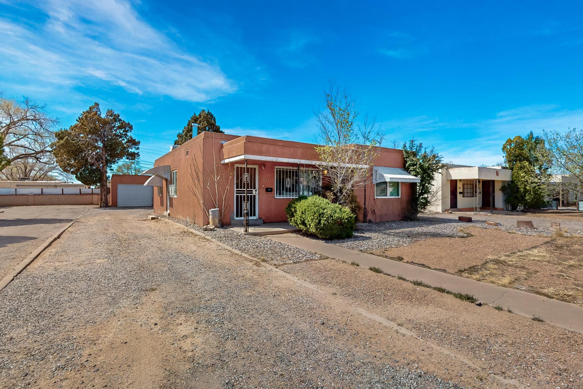 Unlock the potential of this two unit duplex in Albuquerque, ideal for investors or those looking to live in one while renting out the other! Each unit features one bedroom, one bath, along with convenient in-unit, stackable washer/dryers. The detached two car garage provides each unit with ample storage and parking for owners and guests. Windows have been replaced throughout, electrical service upgrade for the building has been completed and one of the units has been remodeled from top to bottom. Roof and evap coolers were replaced in 2019 and plumbing to the street in 2020. Both units are rented on month-to-month basis. Located near Kirtland Air Force Base, VA hospital, and close to local amenities.