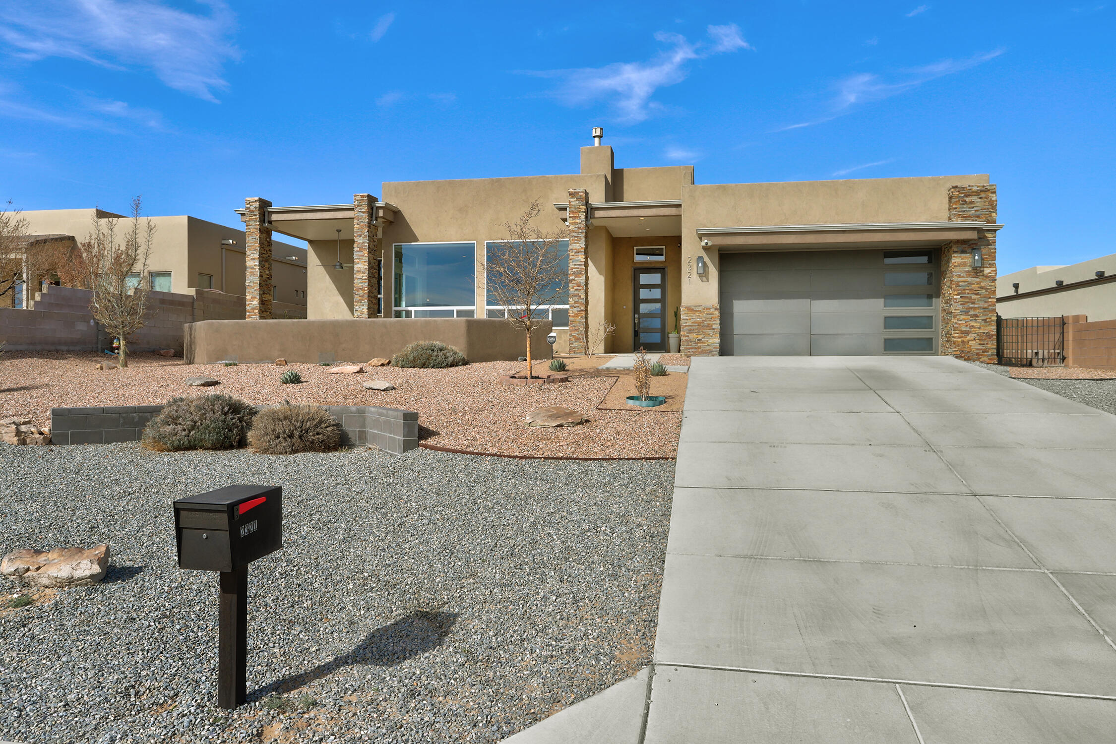 Stunning Contemporary Home with Breathtaking City & Mountain Views! This home offers a perfect blend of modern luxury & natural beauty. The spacious custom kitchen is a chef's dream, featuring high-end cabinetry, quartz countertops, floating shelves, acacia wood-topped island with an attached breakfast table, stainless steel appliances, a wine fridge, & a walk-in pantry. The open-concept living & dining area boasts soaring ceilings, a sleek black granite fireplace, & expansive windows that flood the space with natural light. The private primary suite  offering a spa-like bath with a soaking tub & walk-in shower. large laundry room with a dog bath, & granite countertops. The beautifully landscaped backyard is a serene retreat featuring a gazebo & fruit trees. Owned solar panels!