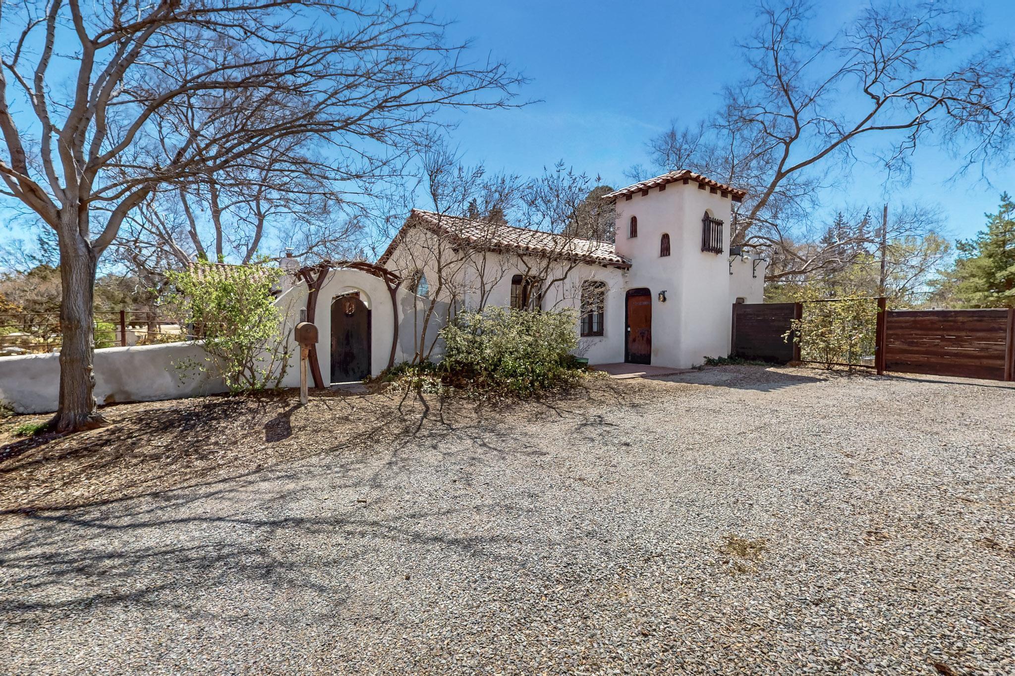 Nestled in Albuquerque's Ridgecrest neighborhood, this Spanish Mediterranean estate is a rare blend of history, craftsmanship, and lush gardens on two large lots. Built by Wright and Katherine Van Deusen, the home features plastered adobe walls, custom red oak floors, original hardware, and custom metalwork. A Chapel Library, stained glass accents, and a gun port in the front door add to its charm. The Secret Garden, like Hidden Park, offers sustainable living with fruit trees, while the sunken rose garden(turtle sanctuary), koi pond, and 100-year-old honeysuckle vines flourish among two towering Lacy Bark Elms. Thoughtfully updated with new HVAC, sewer line, and plumbing, this home calls for a creative owner--someone who will not just live in it, but engage with and evolve alongside it.