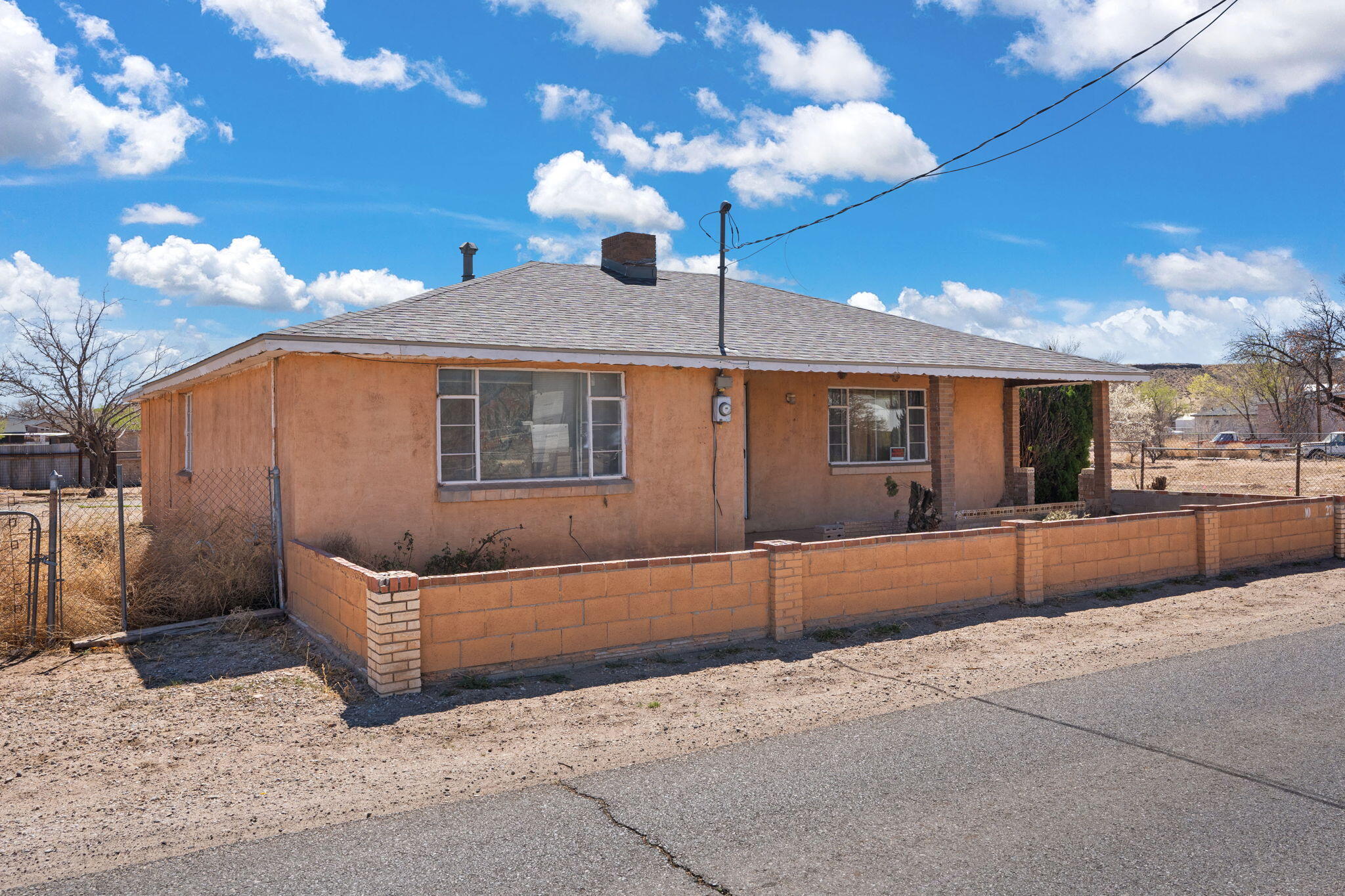 This classic adobe home on an expensive  1.13 acre lot in peaceful Valley Farms offers timeless character and room to grow. The spacious layout includes 3 oversized bedrooms, 1.5 baths, a large living room with a striking wood-burning fireplace, and an oversized kitchen. Recent updates include a newer roof and a 3-car garage. The property's agricultural land holds even more potential--a second well, gas meter, and roadside electricity make it ideal for adding a second home. Sold AS IS, this is a rare opportunity to customize your dream retreat.