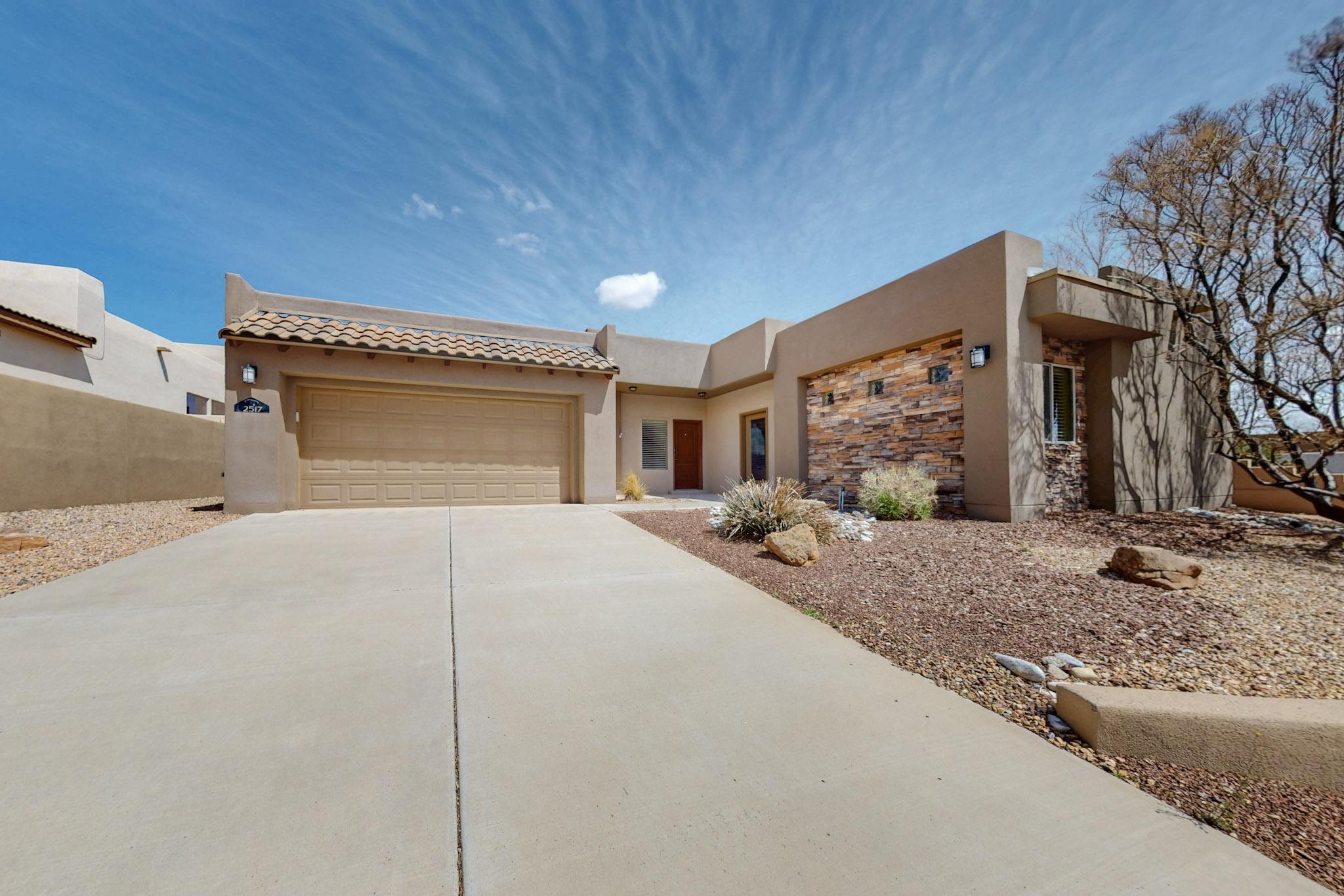 Indulge in refined living with this stunning single-story home featuring a private casita. Thoughtfully designed for modern comfort, it boasts 10' coffered ceilings with skylights, an open-concept layout, and upscale finishes like granite countertops and stainless steel appliances--including a wine cooler. The master suite exudes sophistication, complete with a cozy fireplace, patio access, and an opulent dual-head shower. The fourth bedroom offers casita-style privacy with an en-suite bath and separate entrance. Enjoy landscaped grounds, a covered patio, and eco-friendly features like owned solar, Eco flush toilets, and a tankless water heater. Relish unobstructed views with no rear neighbors, all while being ideally situated for convenient commutes to Santa Fe and Los Alamos. A true oasi
