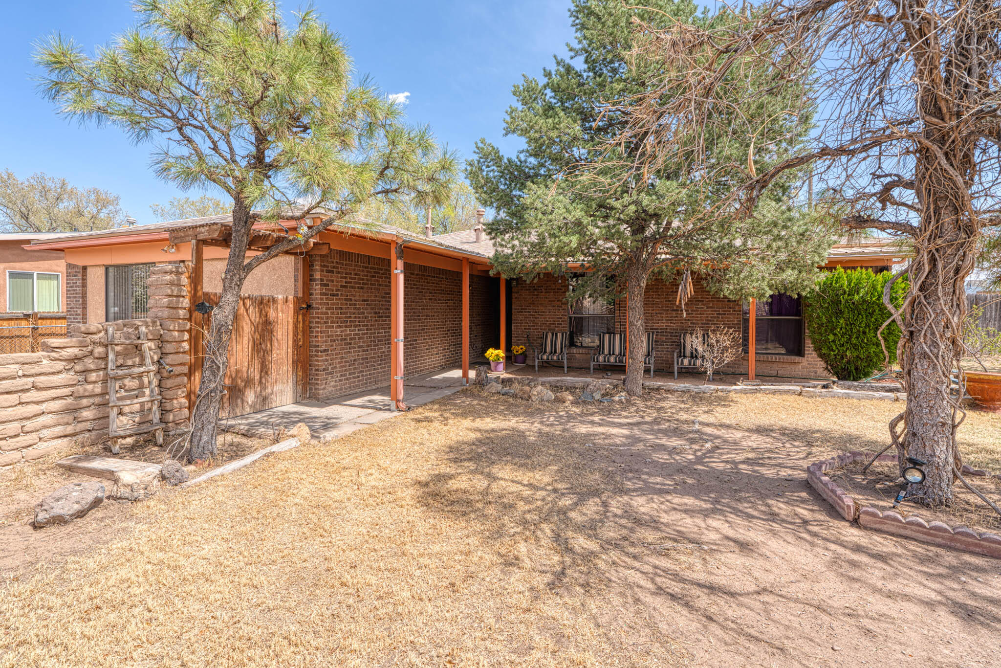 This charming North Valley home is ready for new owners! This great property offers, 3 bedrooms, 1.75 baths, 2 living areas and 1,735 SQFT. Updates include: a new front porch(2023), laminate flooring (2023), Carpet (2025) and a roof (2020). Enjoy outdoor living with the covered patio, backyard access, and two storage sheds. The front courtyard features beautiful exposed Adobe, perfect for creating a private retreat. Additional highlights include a new water heater (2024), a gas stub for the backyard patio, and a Master Cool system. Conveniently located less than a mile from I-40 on a desirable corner lot, this property is not within an HOA or PID restrictions. Don't miss out on this amazing opportunity!