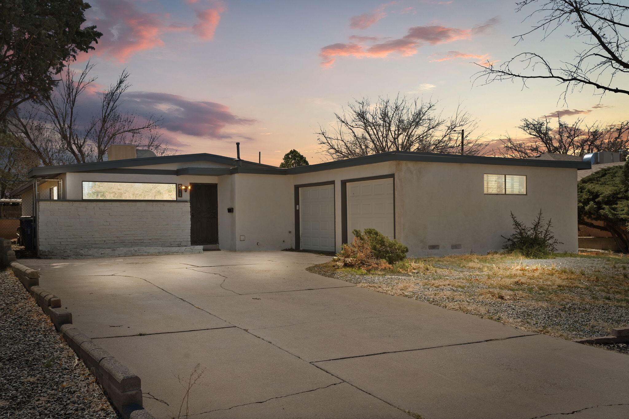 Mid-century charm meets modern elegance in ABQ's NE Heights! Stylishly renovated 3 bed, 2 bath, 2-car garage Chapman home in Mesa Village! Two spacious living areas feature new wood laminate floors, tongue & groove ceilings, and an updated dining room with cozy fireplacea"ideal for entertaining. The brand-new kitchen stuns with rustic backsplash, new appliances, trendy two-tone cabinets, and statement pendant lightsa"your dream modern farmhouse vibe! The Primary Suite shines with dual vanities, new lighting, sleek walk-in shower with glass door, and walk-in closet. Easy I-40 access + space for RV or toys on SW side. Don't miss this beautifully revived 1960s classica"schedule your showing today!