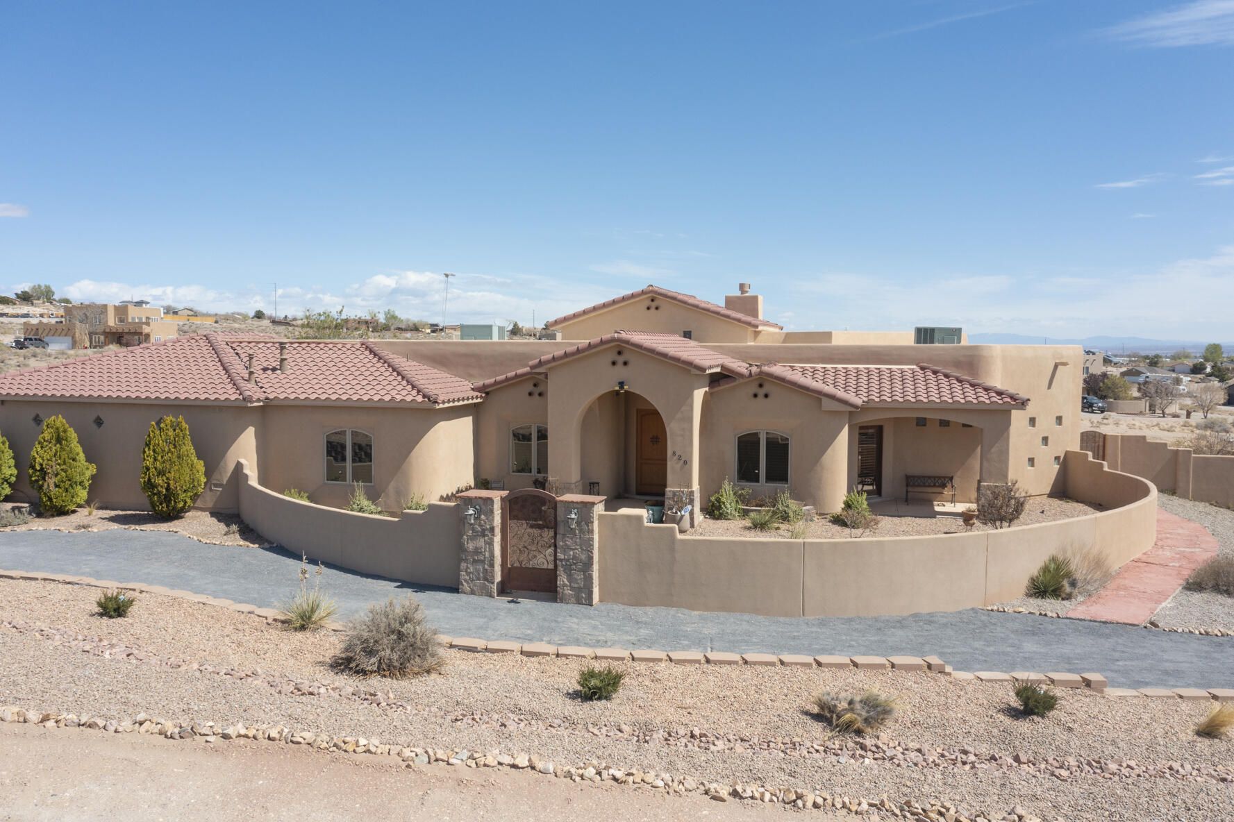 Spectacular Tuscan style home with towering 18-foot ceilings in main living area.  Open concept floor plan allows you to entertain guests while preparing meals in the large kitchen with an island to prep those delicious meals.  Hard surfaces throughout the house with carpet in the bedrooms.  Enjoy the fantastic mountain and city views from your large, covered porch, or the 2-level deck.  This property also includes a 48 X 20 foot heated and cooled RV garage, with its own 3/4 bathroom, to store all your toys or easily converted to additional living space, casita or studio.  Too many other features to list here, so please see the additional properties in the list included in the documents section. Shelves, metal storage unit and rolling tool box in garage do not convey.