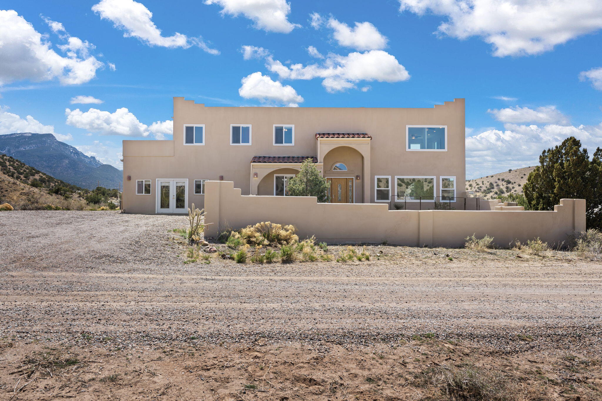 Breathtaking mountain views surround this spectacular Placitas home! Enjoy panoramic vistas of the Sandia & Jemez Mountains and stunning Cabazon sunsets through large, sunny picture windows. This beautifully remodeled home features two versatile bonus rooms--ideal for a den, studio, office, or hobby space. Relax on the expansive deck overlooking Sandia Peak, petroglyphs, and roaming wild horses. A spacious climate controlled workshop offers potential for added living space or easy garage conversion. Southwest living at its finest! Come see it today.