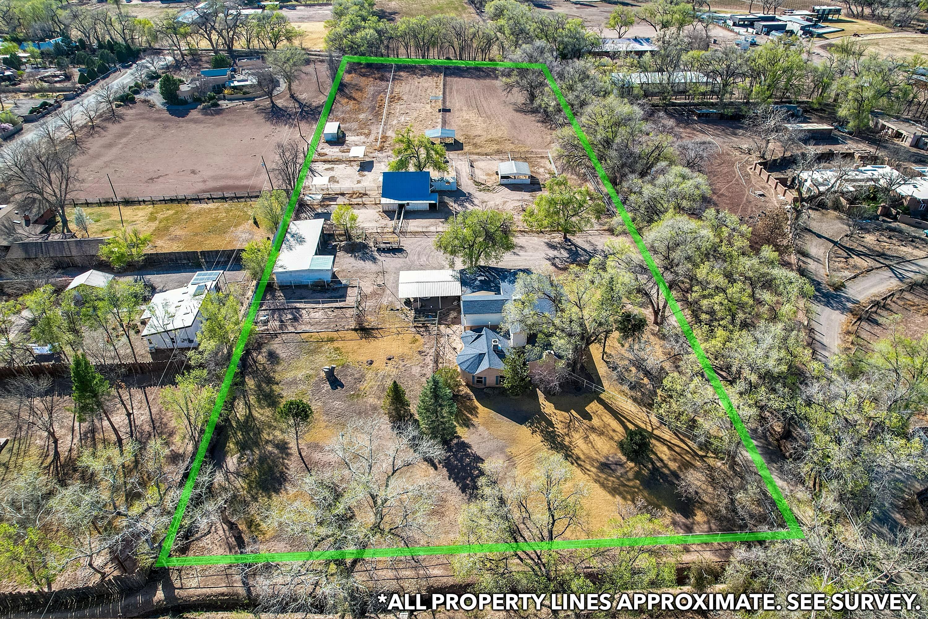 MOTIVATED SELLER- Bring your offer! The ROI is real - it's just waiting for your vision. Tucked away on a quiet lane in the heart of Los Ranchos, a rare 4.38-acre estate is a private sanctuary with all the perks of city living. Fully fenced, and flat--ideal for horses, farming, or simply stretching out under wide open skies. Multiple outbuildings offer endless storage for your passions, from vintage cars to farm gear. Dual water sources (well + city), irrigation, and a modern septic system ensure effortless living. The 4-bed, 3.5-bath home is a work of art--featuring antique brass, a Turkish bath, a wet bar, and a breathtaking Round Room crowned by a historic Northern NM church chandelier. A once-in-a-lifetime property waiting for its next chapter. You don't want to miss this opportunity