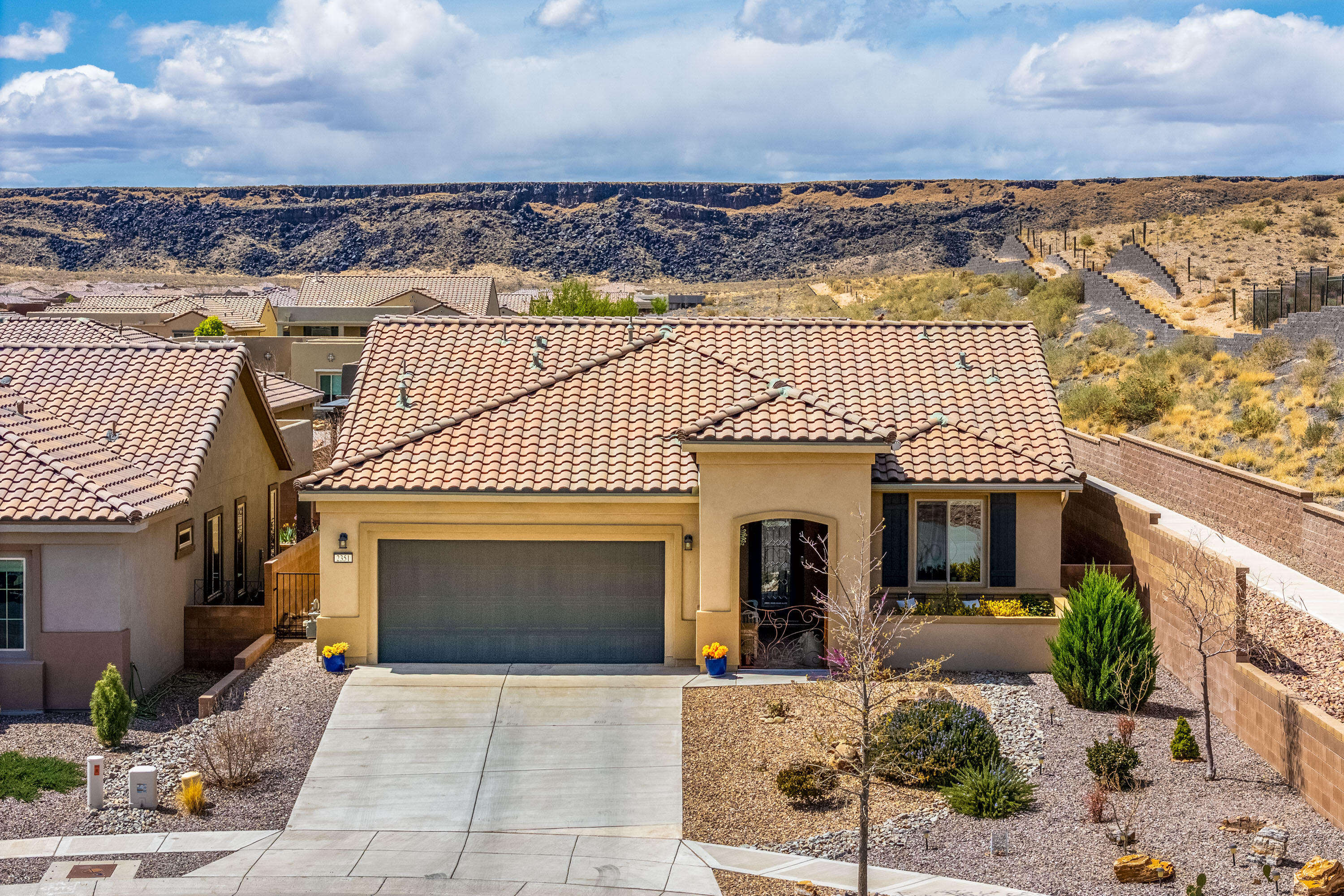 Beautiful Home Built on a Premium View Lot located in the Exclusive 55+Community of Del Webb! Situated at the end of the Cul-de-Sac & steps to the Petroglyph National Monument trails, this 2 or 3BR, 2BA, 2CG home has Forever Views of the Sandia Mountains from the front! Original Owner added many upgrades including: One of a Kind Custom Courtyard Gate, Audio Visual Built-in w/Glass shelves & recessed lights, Bay Window, Exterior Gas Fireplace at back patio, Beautiful 'Linen' Cabinets throughout, Granite Countertops, Raised Dishwasher, Gas Cooktop, 2 Ovens, Range Hood, Garage Epoxy, Stained Concrete at back patio, Pavers in Courtyard, Pergola, Raised Garden Beds, Nice Plantings & Fountain in Backyard!  All Appliances Stay! Custom Thompson Alderwood Buffet w/Copper Top in Dining Room Stays!