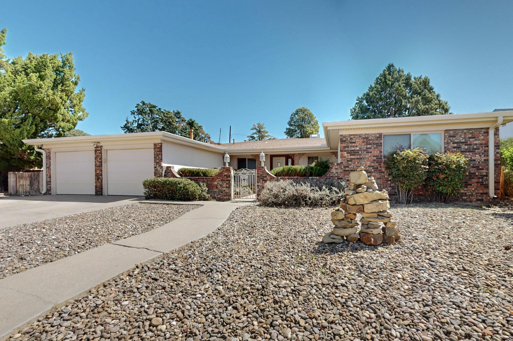 Beautiful 3-bed, 3-bath brick home with 3,143 sq ft in Northeast Albuquerque. Features an open concept layout with a cozy fireplace and custom shelving, sunroom with indoor jacuzzi, spacious kitchen with ample storage, and natural lighting throughout. Enjoy a large laundry room, 2-car garage, and a spacious driveway. Relax on the front patio or entertain on the covered back patio overlooking a large backyard. Includes a storage shed. Close to shops, dining, and more. Don't miss your opportunity to own this stunning home in a prime location!