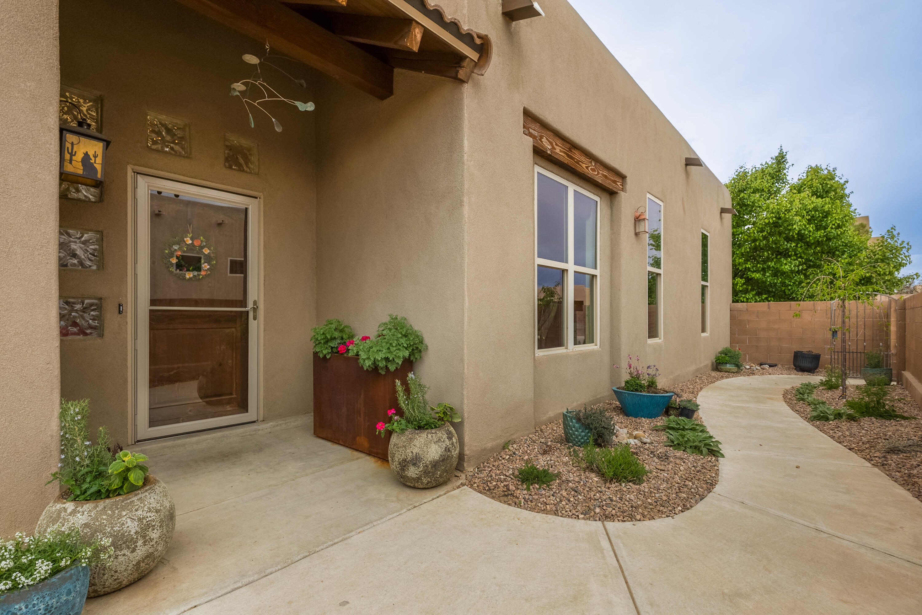 Take in spectacular views of the mountains from any part of the open living space with balloons in the morning & ''golden hour'' sunsets in this Scott Patrick home. Floor to ceiling windows & numerous skylights bring the outside in. Renovated landscaping features drought tolerant plants & covered & open patios so you can enjoy the outdoors year-round. This versatile floorplan offers work from home options & so much more with a front office/media room, plus three other bedrooms each with a sense of privacy. Large primary suite, with custom paint & tray ceilings, make you feel you're in your own hideaway. A pantry in the kitchen & dedicated laundry room add to the conveniences. Quick access to Montano, I-4O, shopping & the Bosque & trails. All this and a new TPO roof & AC!