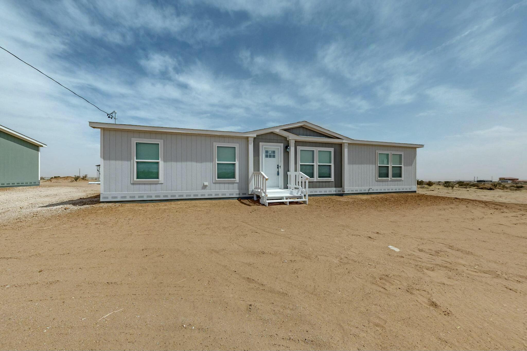 This Brand New Clayton Energy Smart Zero Home is close to shopping at Unser and Southern but still sits in the peace and quietness of the county. Home is in Rio Rancho School District. The Home is on a Permanent Foundation that qualifies for VA, FHA and Conventional loans. Home sits on Half Acre of Land. Home comes with four bedrooms, two bath, an open concept living room, dining room, large kitchen with a large center island. Some of the other features are Full set of Stainless Steel Kitchen Appliances, Ecobee Smart Thermostat that you can operate remotely on your phone with app, Refrigerated Air. Spacious owners suite with luxury bathroom that has a long soaking tub and walk in shower. All of this plus a Two Car Garage.