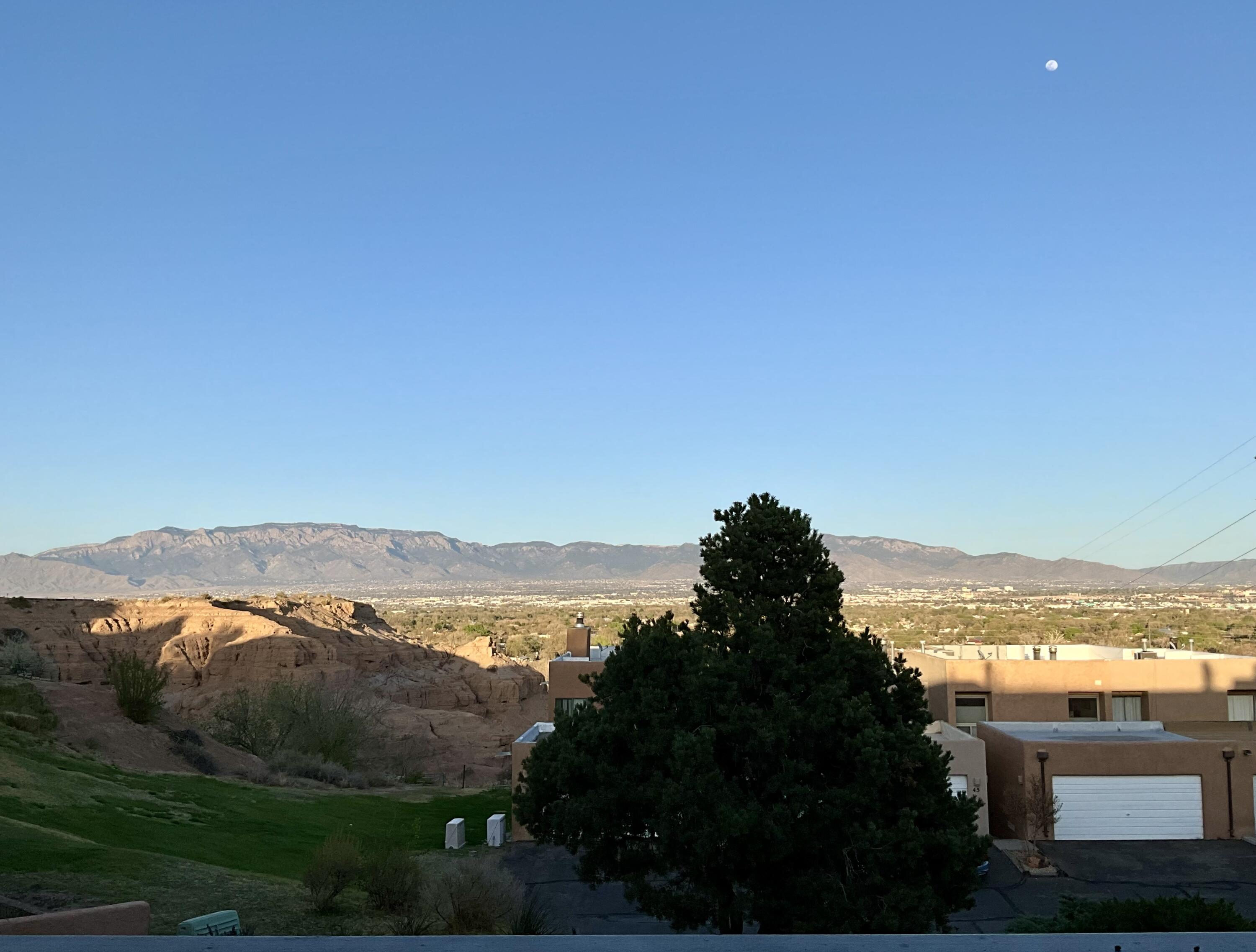 Perfectly situated on a bluff overlooking the Bosque, this exceptional townhome offers sweeping views of the Sandia Mountains, the Rio Grande River, and the sparkling city lights of Albuquerque. Nestled within the gated community of The Westcliff Townhomes--a certified wildlife sanctuary--this home offers a rare blend of privacy, security, and access to nature. Residents of this sought-after enclave enjoy exclusive amenities including a community clubhouse, swimming pool, and beautifully maintained grounds with direct access to Bosque trails--ideal for walking, biking, or simply enjoying the peaceful surroundings. The thoughtfully designed floorplan features soaring 11-foot ceilings and floor-to-ceiling windows that flood the interior with natural light. The main... See More