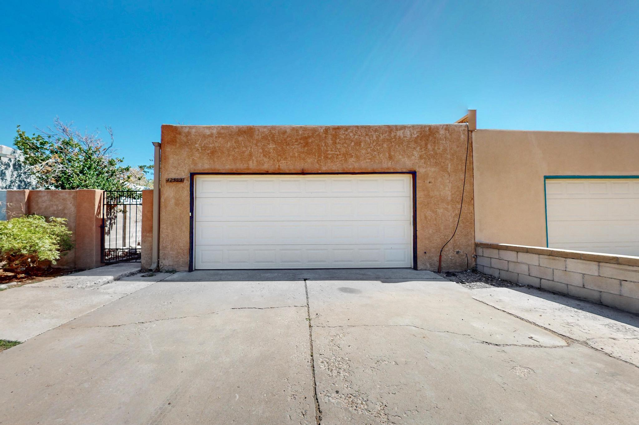 Well-maintained single-level townhouse in SE Albuquerque featuring 3 bedrooms, 2 bathrooms, and 2 living areas. Home includes new carpet, custom tile, and a private courtyard with mature rose bushes. Custom wrought iron fencing and gates add charm and security. The 2-car garage includes built-in workbenches, perfect for storage or projects. Conveniently located with quick freeway access--ideal for commuters. A great blend of comfort, functionality, and location!