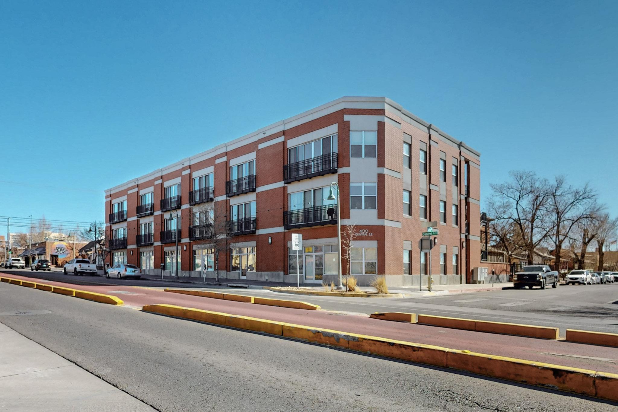 Introducing a rare opportunity to own a ground-floor LIVE/WORK loft in the heart of Downtown Albuquerque! This stylish, modern home offers the perfect balance of living and working space, allowing you to run your by-appointment business while being just steps away from all the vibrant attractions downtown has to offer. With 12-foot ceilings, sleek stained concrete floors, and contemporary glazed kitchen cabinets, this loft exudes sophistication. The luxurious bathroom features a stunning Carrera marble and glass shower enclosure, adding a touch of elegance to your daily routine. The versatile front office space can easily double as a full-sized second bedroom, making it ideal for a variety of needs. HOA Fees cover the building and pool maintenance, water, sewer and trash.