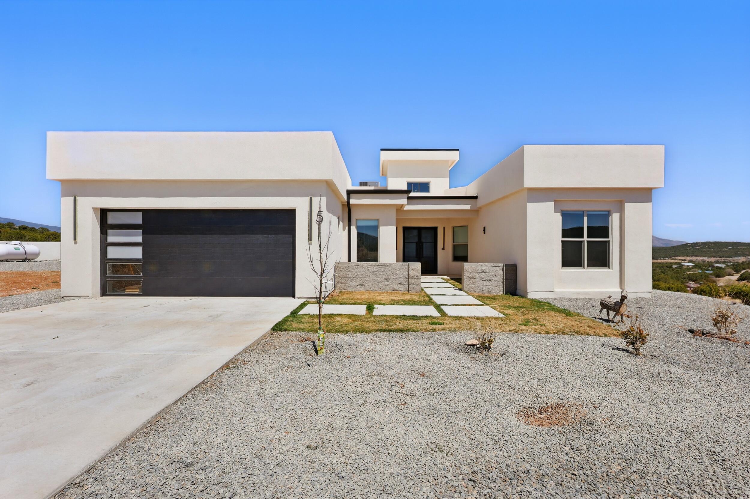 Perched on two sprawling acres in the tranquil heart of Tijeras at the end of a cul-de-sac in the prestigious Nature Pointe Community, this modern contemporary gem blends architectural sophistication with New Mexico's raw natural beauty. With 4 potential bedrooms and 3 bathrooms, step inside to an open-concept floorplan that is equal parts functional and fabulous. The main living area with soaring ceilings and oversized windows flood the space with natural light and panoramic views.The primary suite is a private sanctuary, complete with a spa-inspired bathroom. The rooftop deck is perfect for basking in the peace and quiet that 2 acres of high desert can provide. Clubhouse access filled with an abundance of upscale amenities including an indoor pool, sauna and more! www.naturepointe.co