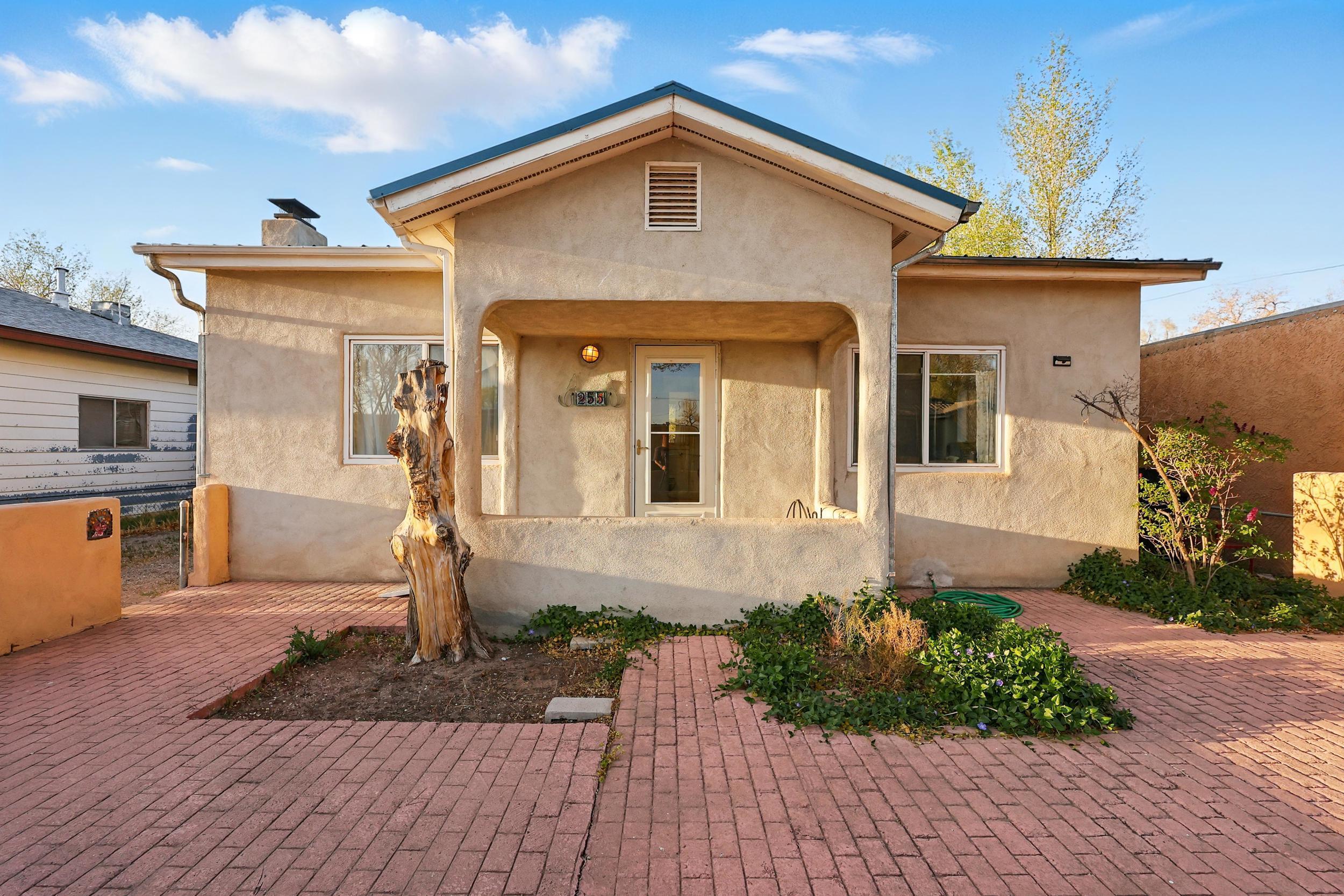 Charming 2-bedroom, 2-bathroom home in Albuquerque's North Valley. This 1,341 sq ft residence features beautiful hardwood floors, a cozy fireplace, and a spacious backyard with ditch rights. Recent updates include a new roof (2021), water heater (2019), and kitchen appliances as well as the front bathroom has been updated and the home was converted from evaporative and Mini Splits were installed. An attached in-law suite offers additional living space or potential rental income. Located near the National Hispanic Cultural Center and local parks, this home provides both comfort and convenience. Experience the blend of historic charm and modern amenities in this well-maintained property.