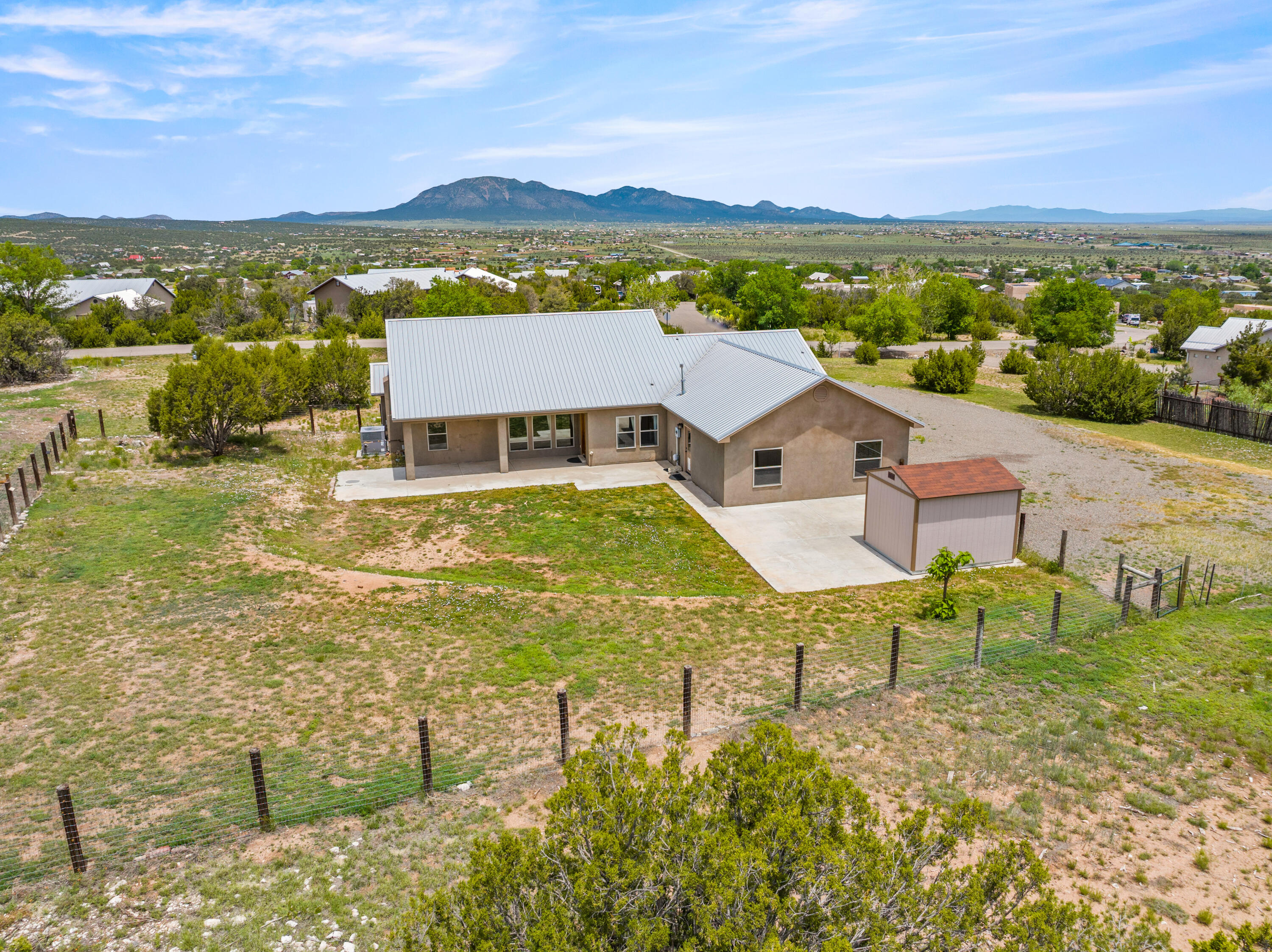 Welcome to this stunning single-story home on a full acre in Coyote Crossings Estates with views of the San Pedro mountains! Enjoy the tranquility of country living and convenience of nearby shopping and services just minutes away. Step inside to an open floor plan, perfect for both entertaining and everyday living. The spacious great room is accented by a cozy corner gas fireplace, raised ceilings, and an abundance of natural light. The gourmet kitchen is a chef's dream, featuring 42'' cabinetry, granite countertops, and ample storage. The well-designed split floor plan ensures privacy and you can luxuriate in your ensuite bath, complete with a soaking tub, custom-tiled walk-in shower and a huge walk-in closet. With the fenced backyard and oversized garage, you have room for everything!