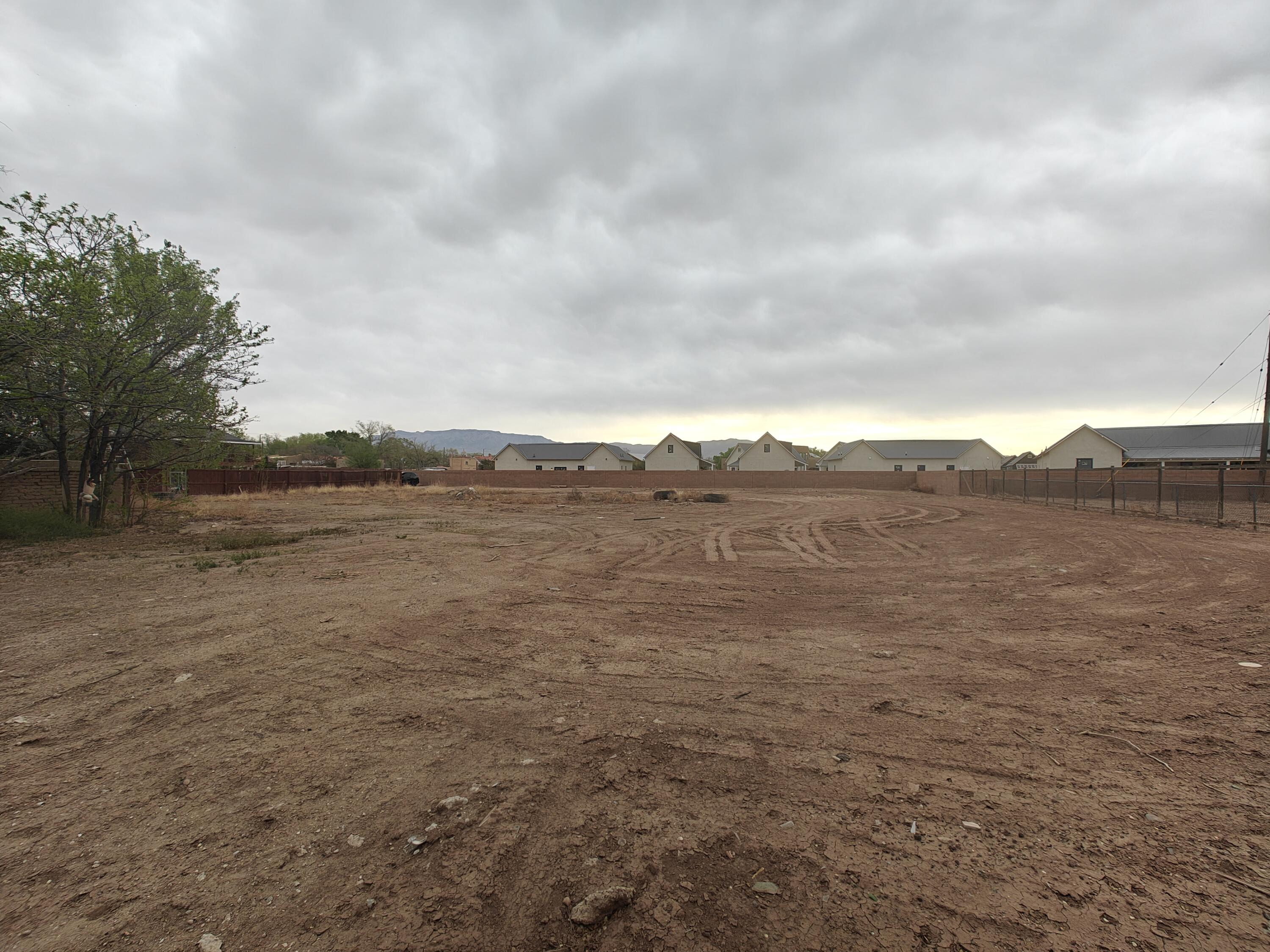 In the heart of Albuquerque's North Valley, 1918 San Martin NW offers a private 0.25-acre lot just off Rio Grande and Griegos. Cleared, flat, and ready to build, this lot sits on a quiet private road surrounded by mature trees and custom homes. Utilities are nearby, and the location is unbeatable--just minutes from the Bosque, walking trails, Old Town, and Downtown. Whether you're ready to build your forever home or secure land in a high-demand area, this is a rare chance to invest in timeless charm and privacy. Being sold as a package for over 1/2 acre for $300,000. Other address is 1920 San Martin Place NW ABQ, NM 87107.