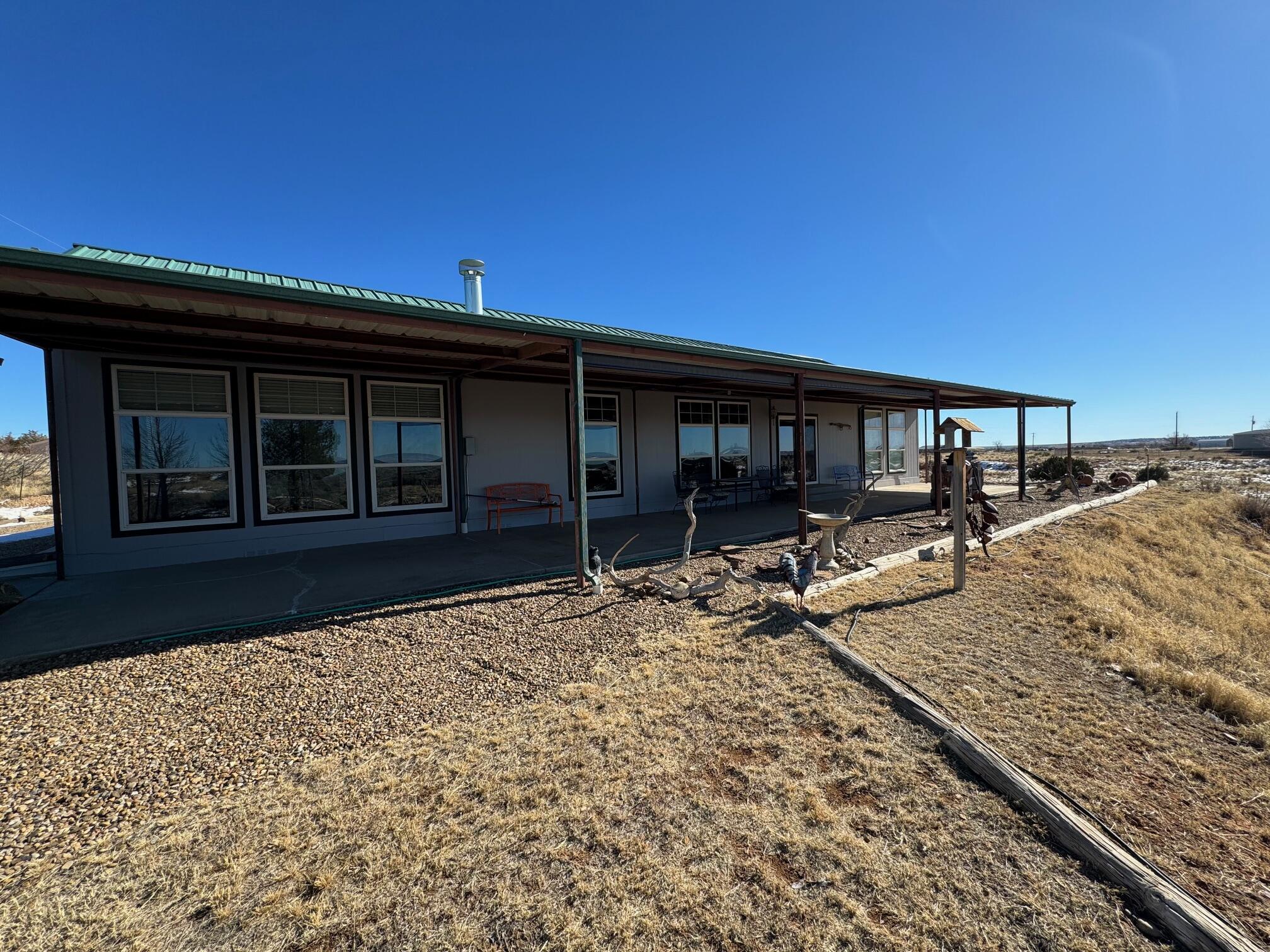 Original owner! Fabulous 3 bedroom, 2 full bathroom modular home situated on 1.82 Acres at Ute Lake in Logan NM! 1 One mile to the main marina & boat ramps. Views of the lake from multiple rooms. Expanded 15'x75' covered rear patio. 4 car attached garage. Open floorplan w/split bedrooms. Spacious kitchen features wood cabinetry, tile counter tops w/custom tile backsplash, oversize pantry, tile floors, island, breakfast bar, electric range, microwave, DW & refrigerator. Living room includes wood burning fireplace , coffered ceiling & wall of windows facing the lake w/electric blinds. Massive 19'x16' Owners suite features lake views, a walk-in closet, dbl sinks, garden tub & separate shower w/custom tile surround. Spacious secondary bedrooms. Large laundry room w/wash sink & 2nd refrig.