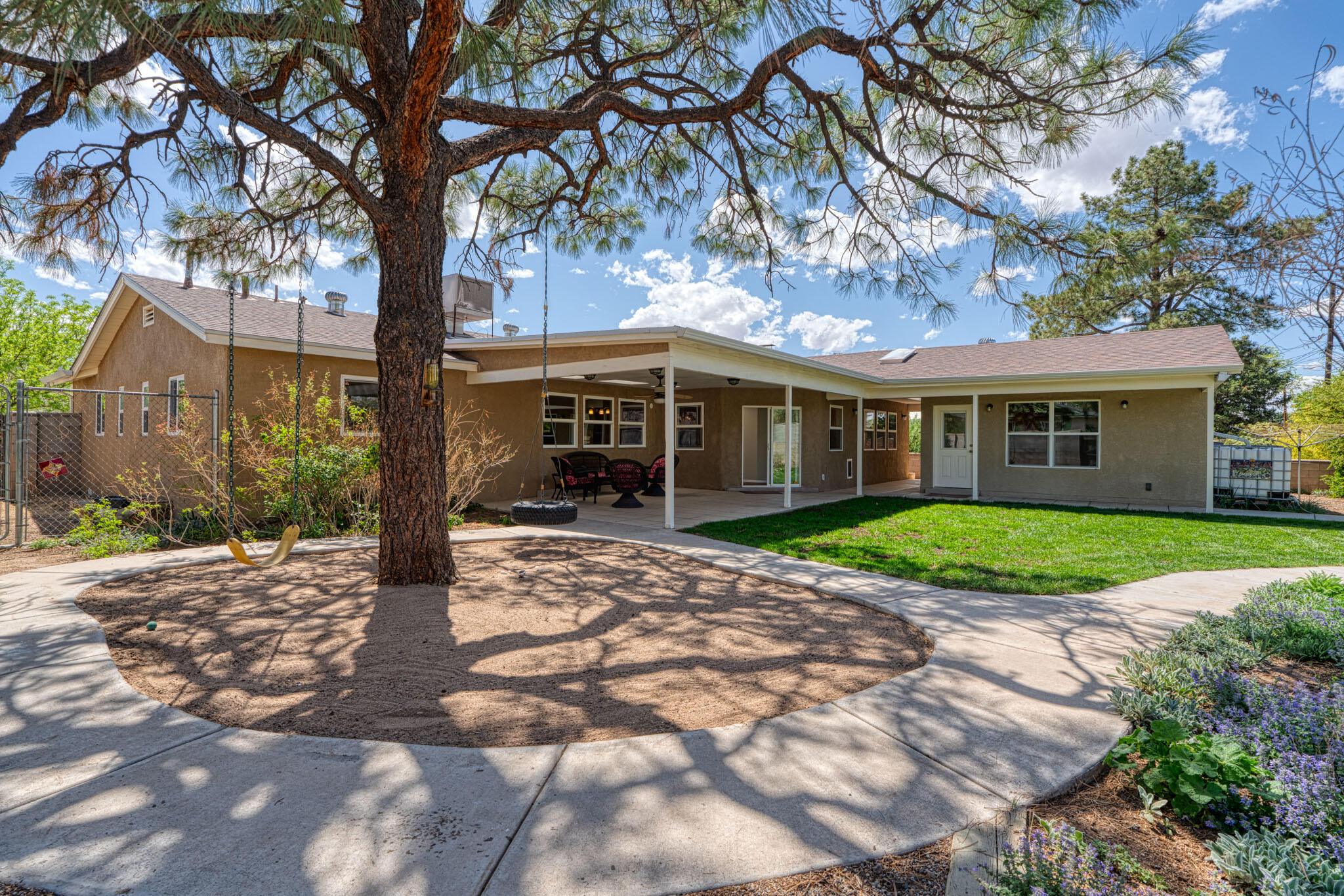Coveted One Level Classic Mossman, Meticulously Maintained, Artfully Expanded and Updated * Stunning CASITA: Main Room Kitchenette, Full Bath, Large Storage Room * Large Lush Private .26 acre Corner Lot * Classic Hardwood Floors * 15 Panel Owned Solar *Spacious Family Room boasts Masonry fireplace, stained concrete floors, custom built-ins and offers so many options. Bountiful storage thru-out! Expansive covered back patio with 9' ceilings. Updated windows. Amazing natural scape front yard. Stunning Artistic 80' Mosaic on East perimeter wall! Paseo del Nordeste Recreation Trail access nearby. 'In Town Country' yet Centrally located to a plethora of shops, services, Uptown Mall, Coronado Mall, Airport, Downtown, Air Force Base. 2 Sheds, SEE HELPFUL ONLINE DOCUMENTS