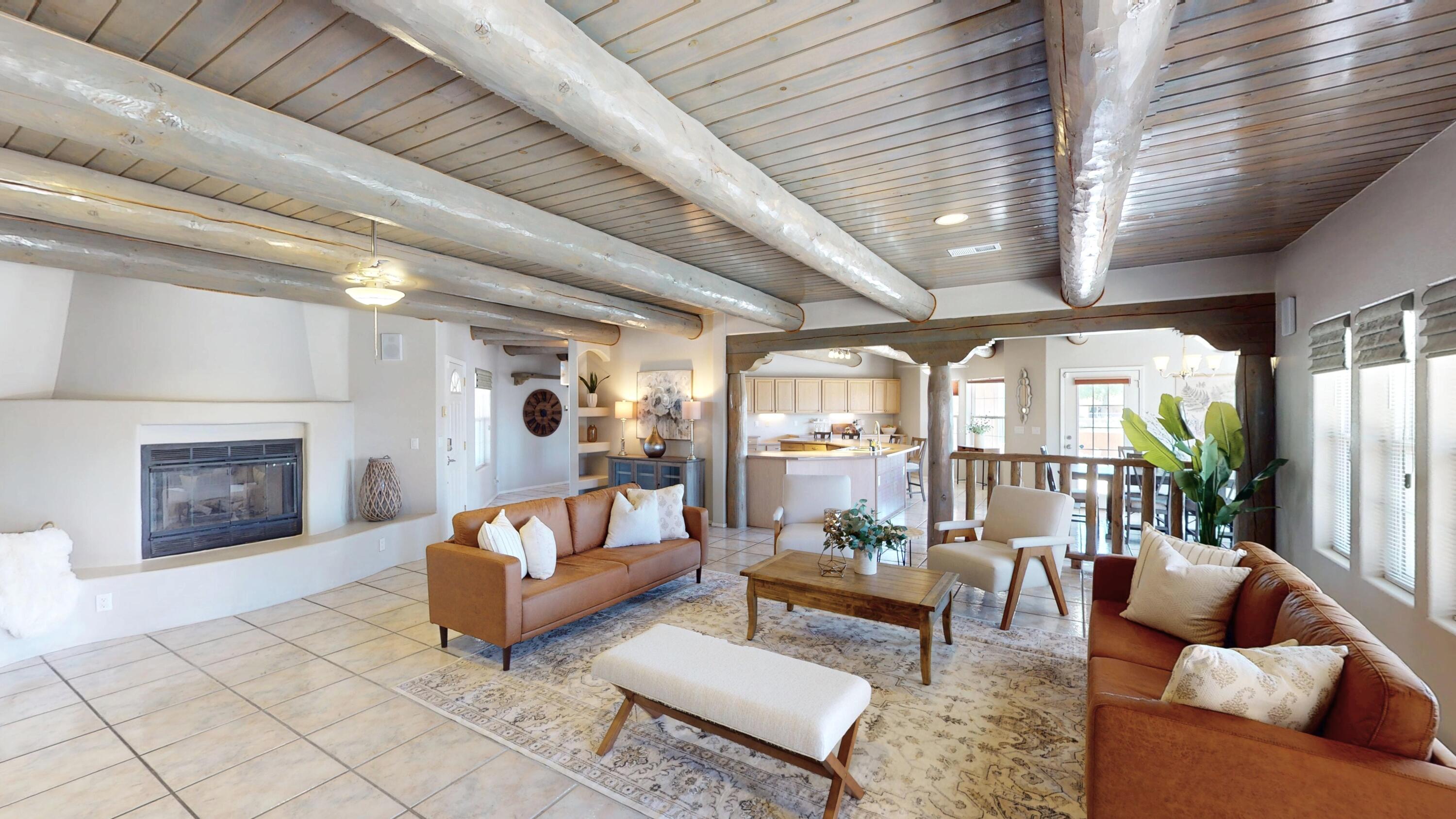 Step into a world where rustic charm meets modern luxury in this stunning Albuquerque gem. Majestic wood-beamed ceilings create an airy ambiance throughout, while the inviting fireplace forms the heart of the home. The gourmet kitchen, a culinary enthusiast's dream, boasts ample counter space and state-of-the-art appliances. Three beautifully appointed and spacious bedrooms offer tranquil retreats. With plenty of indoor and outdoor gathering spaces, entertaining is a breeze. This harmonious blend of Southwestern allure and contemporary comfort isn't just a house - it's the canvas for your ideal lifestyle.