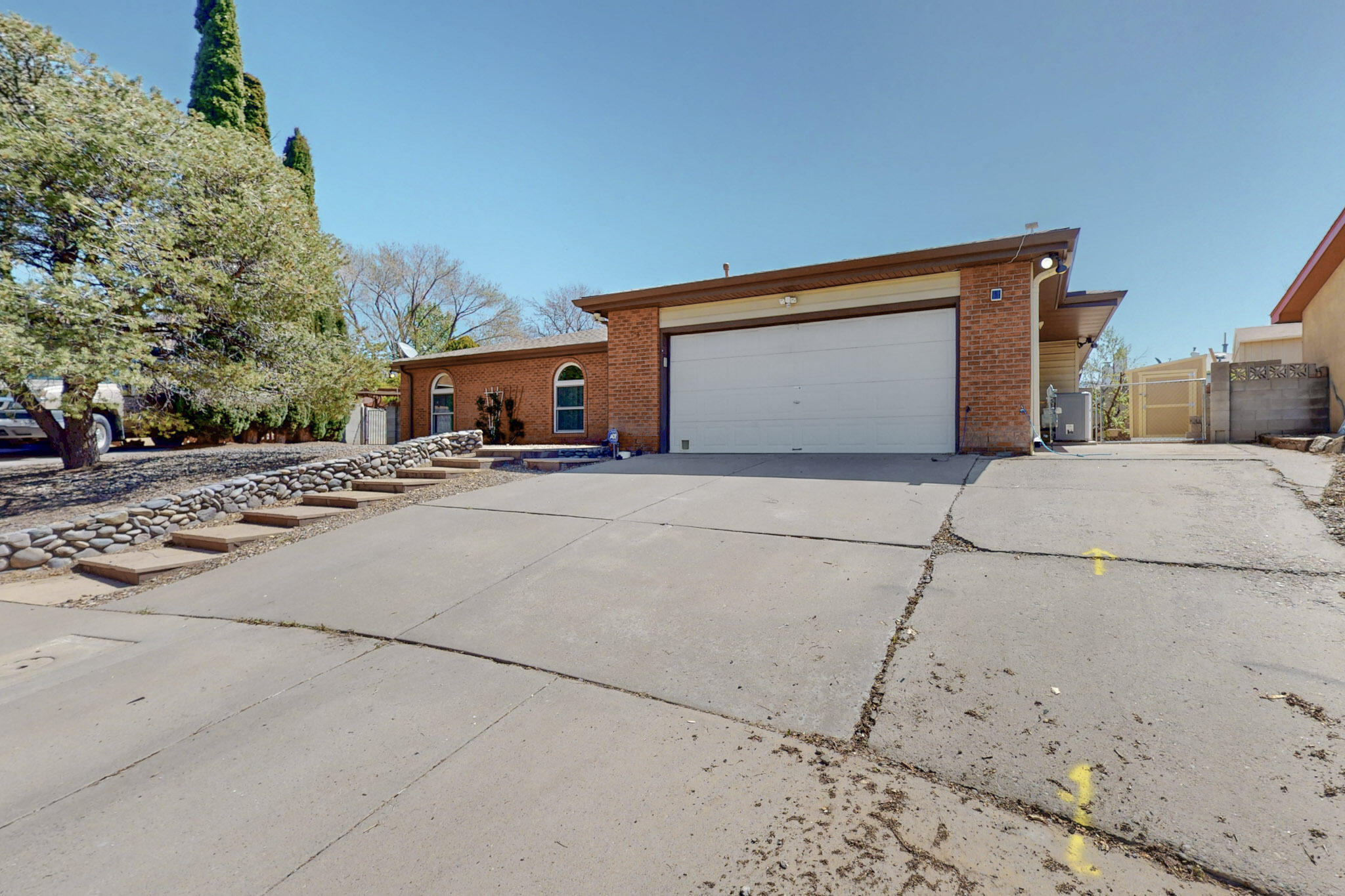 This well-maintained home offers great value in one of Albuquerque's top neighborhoods, within the sought-after La Cueva High School district. Conveniently located near shopping, dining, grocery stores, and fitness centers, it features four spacious bedrooms and two living areas, perfect for flexible living. Enjoy cozy nights by the fireplace or relax indoors in comfort. The beautifully kept, low-maintenance backyard includes backyard access and a versatile work shed. Thoughtful updates throughout reflect pride of ownership, making this home truly move-in ready.