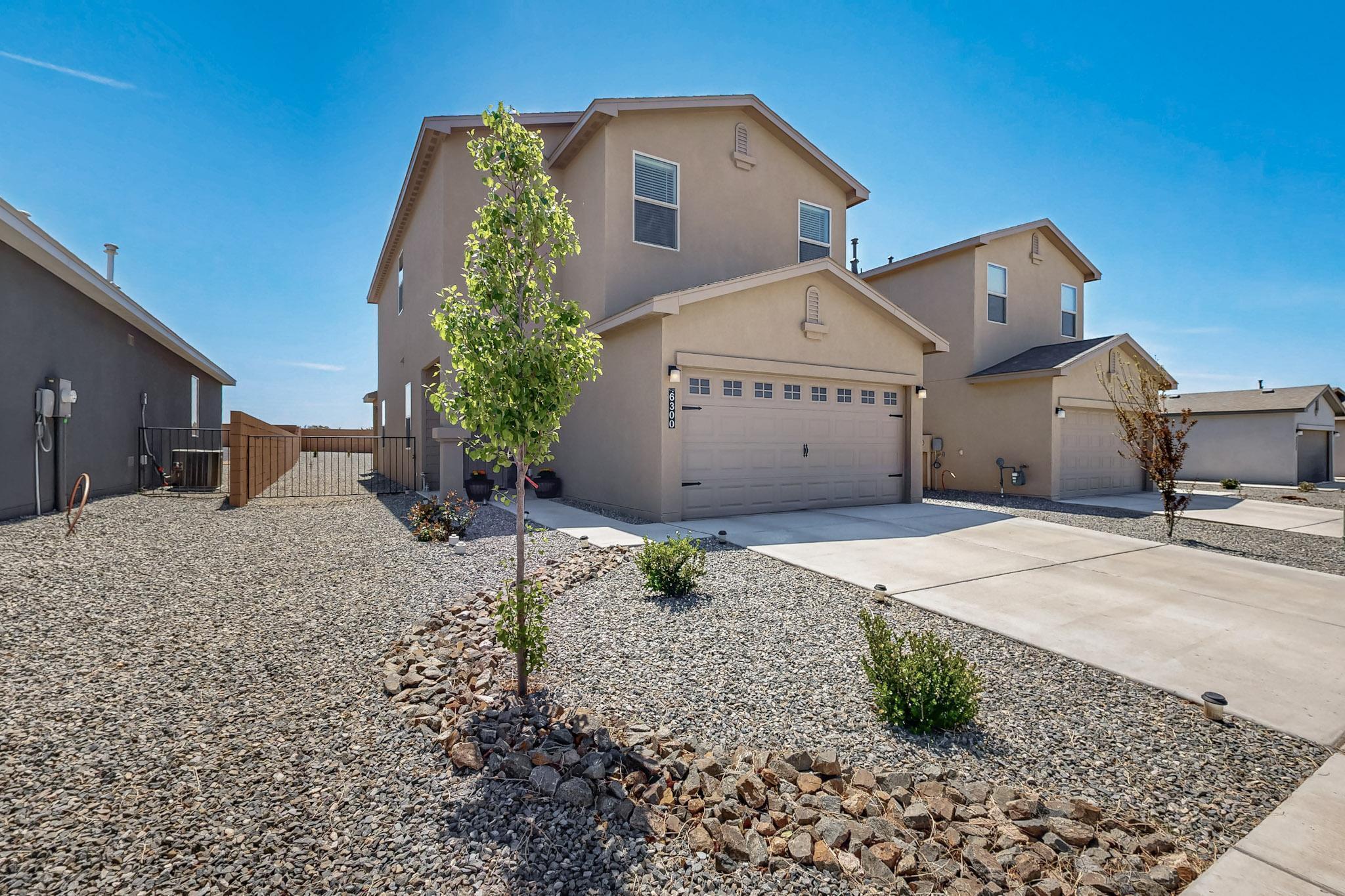 Stunning 2023 Twilight Home in Rio Rancho's Mountain Hawk community! This 4-bed, 3-bath gem offers a bright open floor plan with 9' ceilings and a modern kitchen featuring a large island, stainless steel appliances, and pantry.  Enjoy breathtaking mountain views from your fully landscaped backyard, perfect for relaxing or entertaining! Features include upstairs laundry, under-stair storage, EV charging outlet in the 2-car garage, and refrigerated air for those hot summer days!  The generous backyard with no rear neighbors and a covered patio is perfect for entertaining or relaxation, while community amenities include scenic parks, walking paths, and a dog park. Plus, you're minutes from A- Rated Schools and Enchanted Hills Plaza, where shopping, dining, and entertainment await!