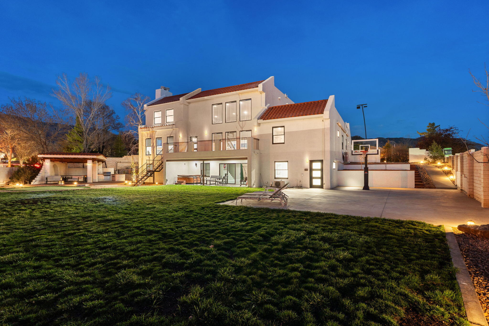 Luxury Living in Tanoan East - Fully Remodeled 6-Bedroom Estate with Mountain Views! Discover unparalleled elegance at 6401MeadowHills, a fully upgraded 6,223 sq. ft. masterpiece nestled in the exclusive Tanoan East Country Club. This 6-bedroom, 5-bathroom home has beenreimaginedwith designer touches, cutting-edge technology, and a seamless indoor-outdoor living experience. The chef's kitchen is a showstopper withcustom cabinetry,quartz countertops, and premium GE Monogram appliances, including a 6-burner gas cooktop with griddle and double ovens. The open-concept living areaboasts a 48'' gas fireplace, an Austin stone accent wall, and recessed LED lighting. Retreat to the primary suite oasis, where you'll find awood-burningfireplace, spa-like wet room with stone soaker tub.