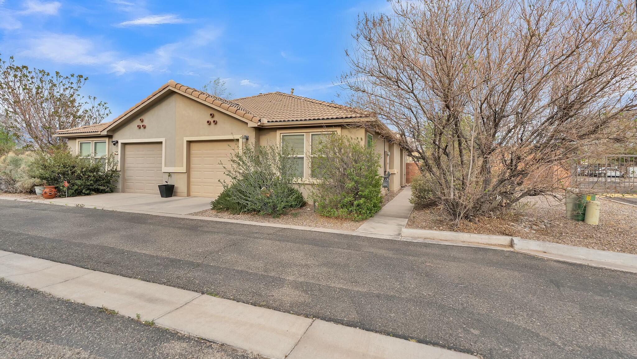Discover this charming single-story townhome set on a corner lot in a gated community. Featuring one spacious bedroom and a full bath, the home boasts an open floor plan with abundant natural light. Enjoy the large kitchen with ample cabinet space, a pantry, and multiple seating areas including breakfast nook/dining area and Island seating. The primary bedroom provides a peaceful retreat, while the expansive backyard offers walled privacy and stunning Sandia Mountain views. Includes an attached one car garage, refrigerated air and tankless water heater. With HOA covering roof and stucco, plus access to a clubhouse with a gym, this townhome offers comfort and convenience in a vibrant setting.