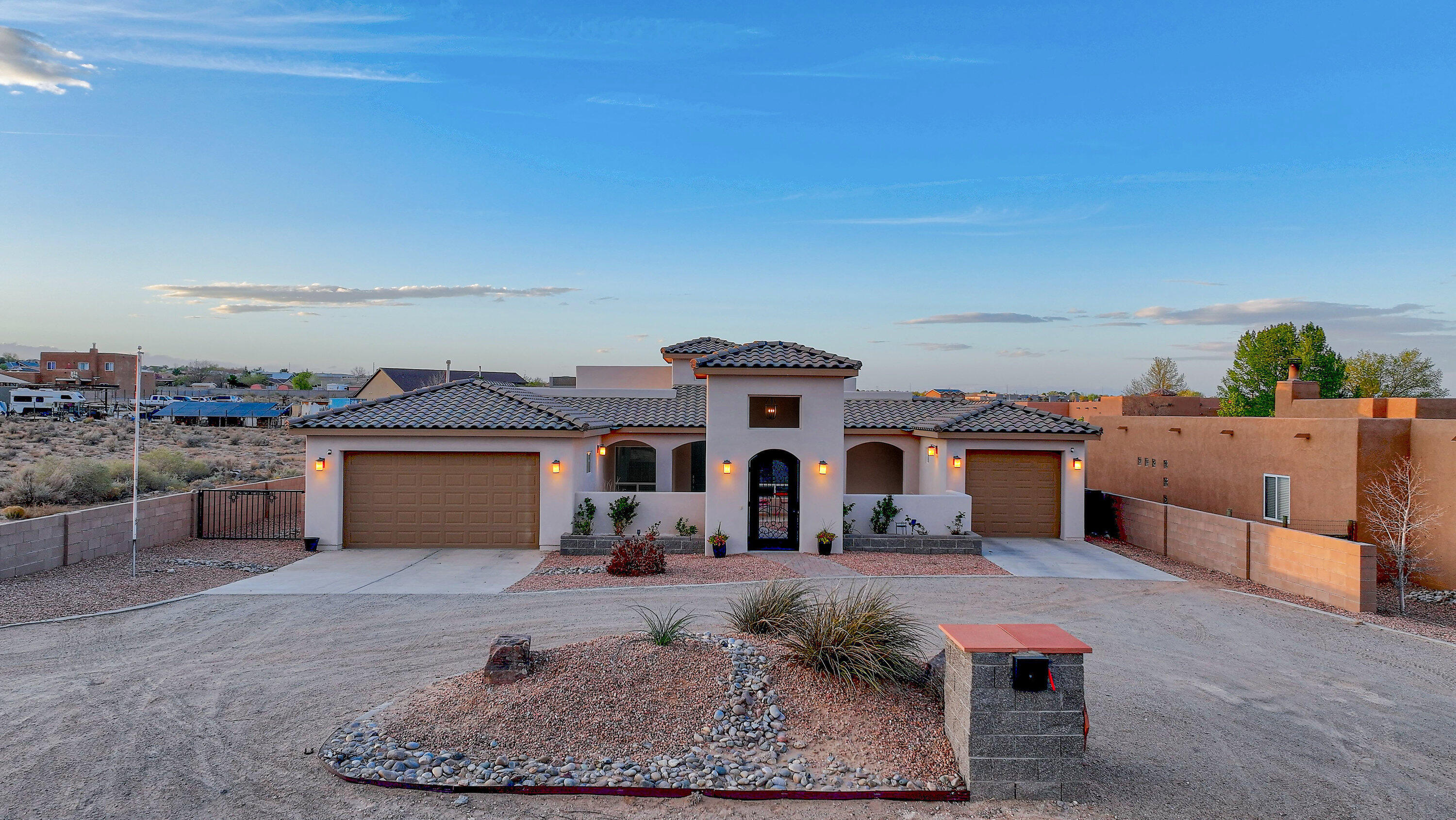Discover refined living in Rio Rancho. This stunning home features five spacious bedrooms, along with an office and den, perfect for work or leisure. Chef's delight in the kitchen with gas range cooktop, stainless steel appliances, and tons of cabinet space. The primary suite is grand with high ceilings, en-suite bathroom with dbl vanities, spacious shower, tub, and beautiful closet. The additional 4 bedrooms are well appointed with tall ceilings. Enjoy your private outdoor living space, complete with a fully equipped outdoor kitchen, perfect for hosting gatherings or enjoying tranquil evenings. The covered porch provides the ideal spot to unwind while appreciating the stunning sunsets. With a two-car garage and an additional third bay, this property harmonizes luxury and practicality.
